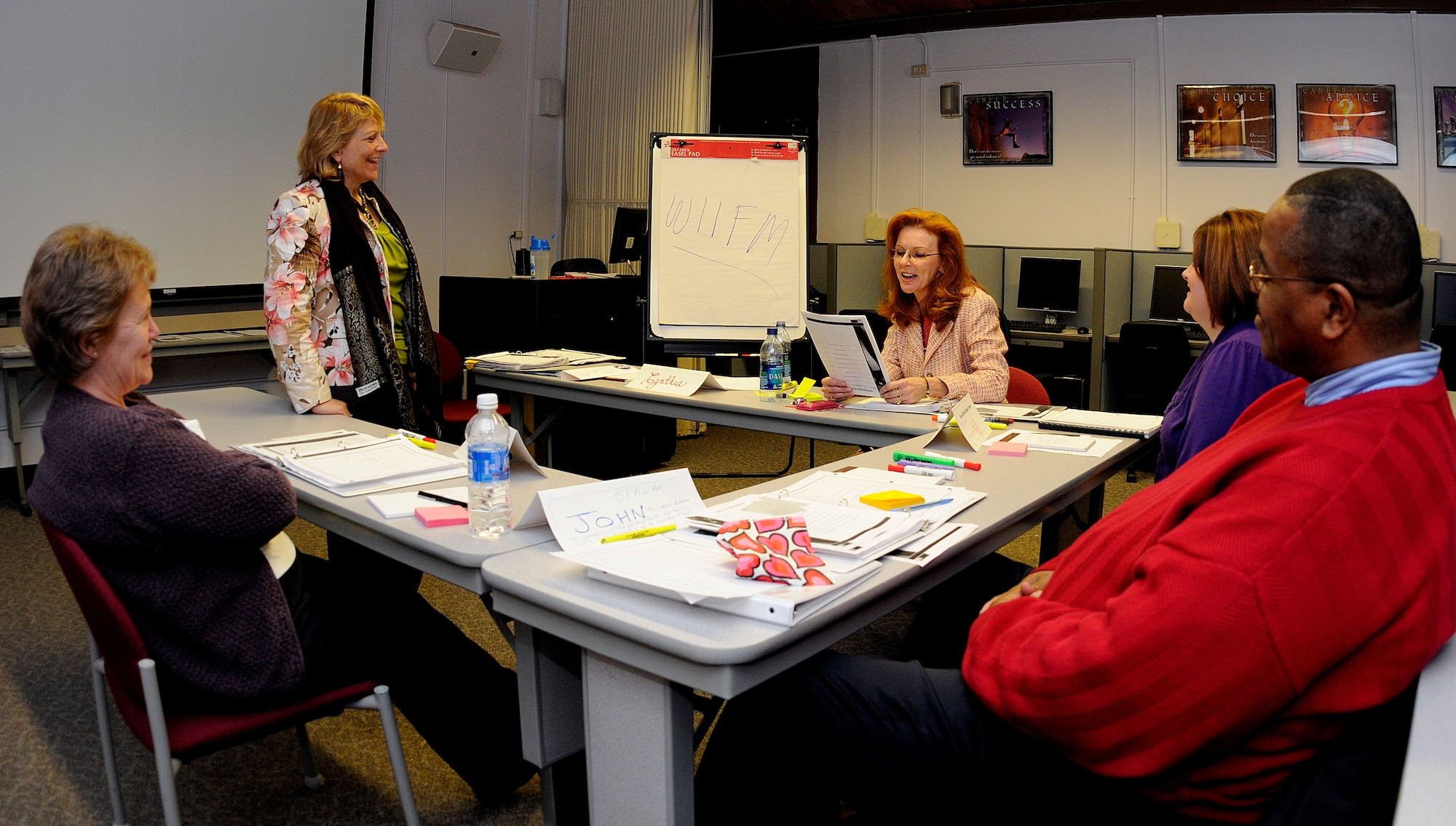 Fleet and Family Support Center Ombudsman Coordinator Becky Bowers, standing, leads a class in an interactive discussion on how to 'sell' the Navy-wide Ombudsman program to spouses during a Navy Ombudsman Basic Training Course, Feb. 14 on Joint Base Charleston - Weapons Station. Established Sept. 14, 1970, the Ombudsman program improves mission readiness through improved family readiness. (U.S. Navy photo/Mass Communication Specialist 1st Class Jennifer Hudson)