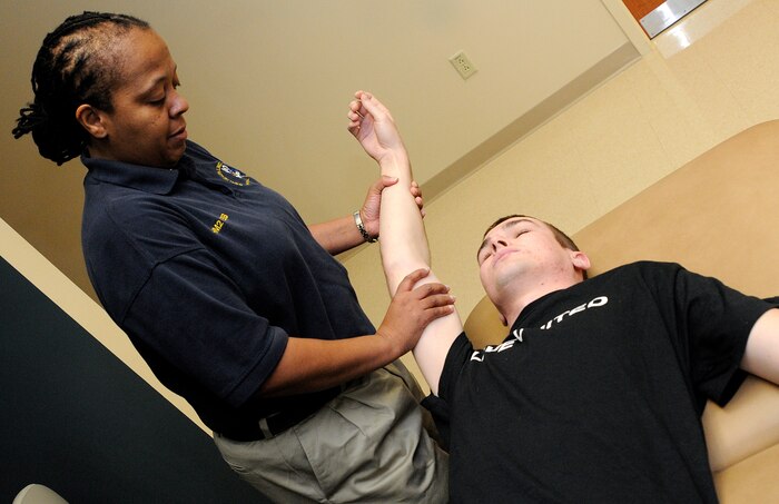 Hospital Corpsman 2nd Class Kwajalien Webb, a Physical Therapy technician, conducts an upper limb tension test on Machinist's Mate 3rd Class Levi Dupler's right shoulder during a session at the Physical Therapy Department at Naval Health Clinic Charleston, Feb. 10. PT technicians help patients rebuild muscle memory by improving and restoring overall mobility and functionality to an injury in order to get a patient back to full duty. (U.S. Navy photo/Mass Communication Specialist 1st Class Jennifer Hudson)