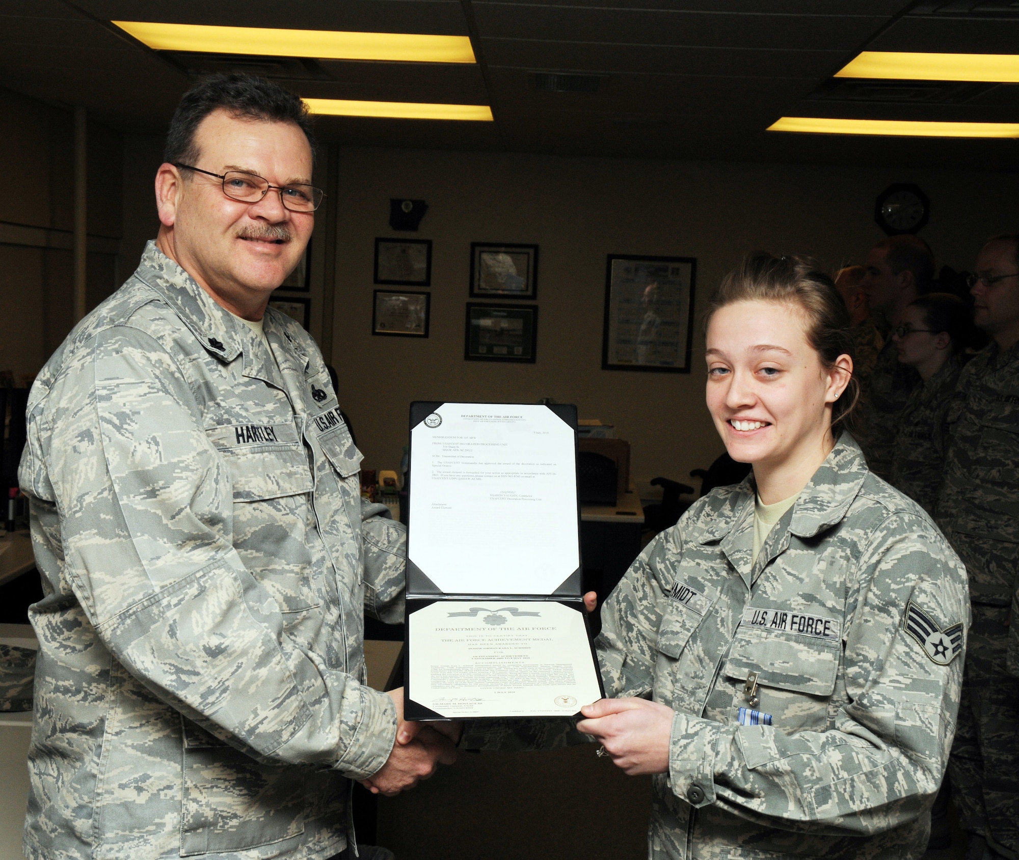 Senior Airman Kara Schmidt was awarded the Air Force Achievement Medal for her outstanding work performance. Lt. Col. Doug Hartley presented her the medal. (U.S. Air Force photo/Tech. Sgt. Justin Huett)