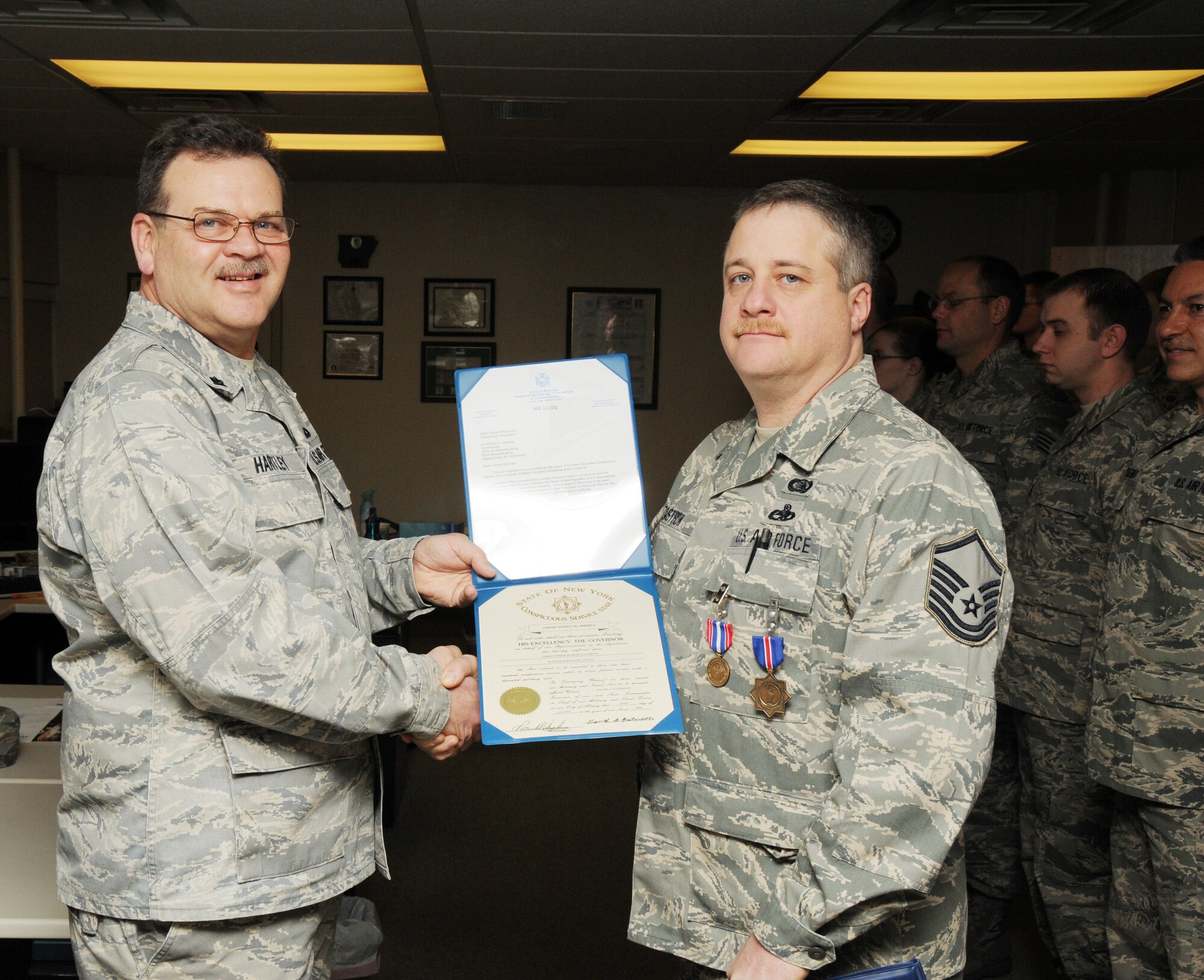 Master Sgt. Chris Zastrow from the 107th AW Communications Flight was awarded both the State of New York Medal for Merit and the State of New York Conspicuous Service Star for his dedication and outstanding work performance. . Lt. Col. Doug Hartley presented his the medals. (U.S. Air Force photo/Tech. Sgt. Justin Huett)