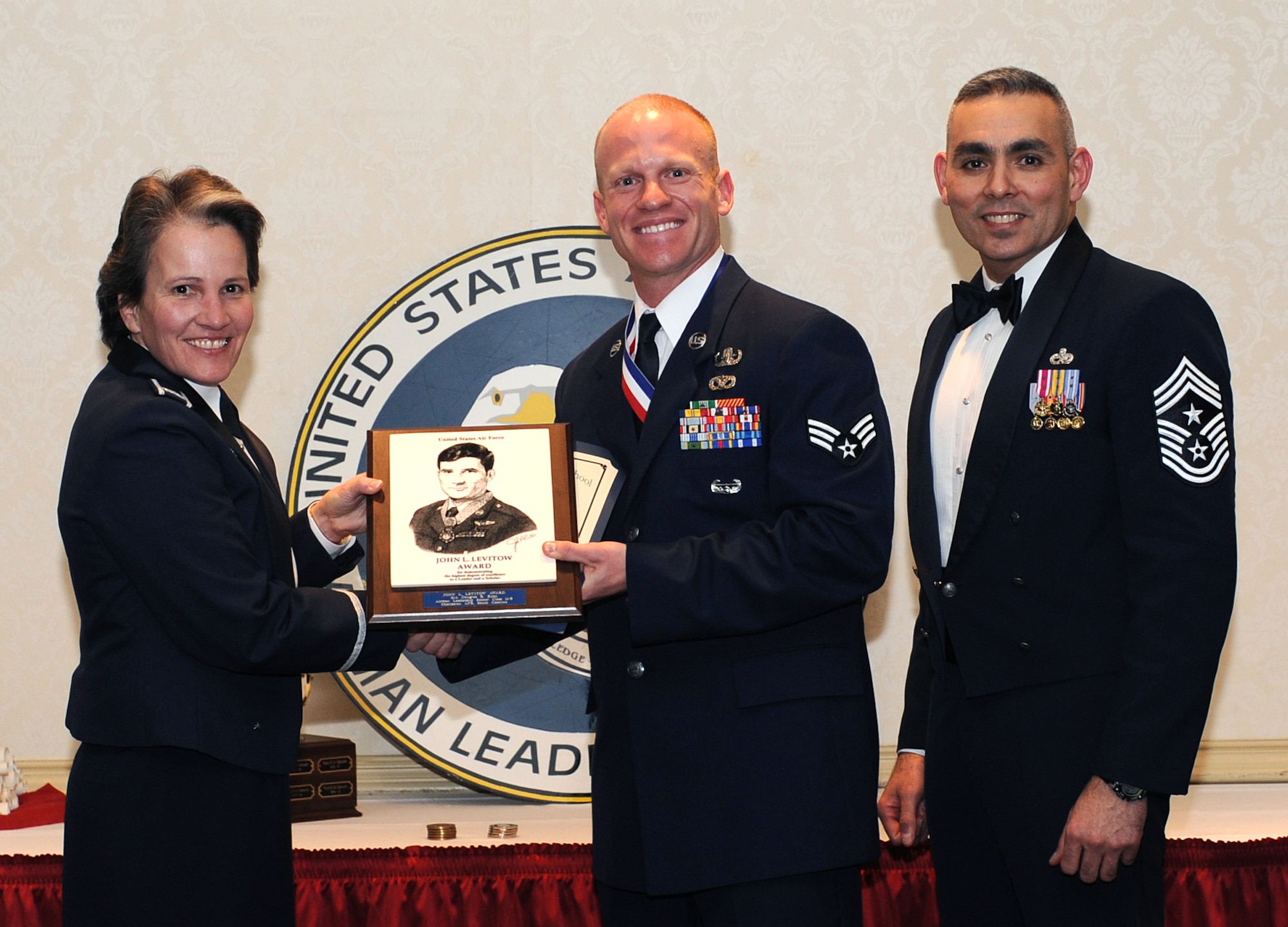 Senior Airman Douglas Ryan receives the John L. Levitow Award from Col. Martha Meeker and Chief Master Sgt. Jose LugoSantiago, during the Airman Leadership School graduation Feb. 10 at the Charleston Club. Colonel Meeker is the Joint Base Charleston commander and Chief LugoSantiago is the 628th Air Base Wing command chief. Airman Ryan is assigned to the 628th Civil Engineer Squadron. 

The Distinguished Graduates for class 11-B were Senior Airman David Goater from the 628th Logistics Readiness Squadron, Staff Sgt. Cory Sanders from the 628th Security Forces Squadron and Staff Sgt. Nicole Mickle from the 628 ABW. 

Airman Goater also won the Academic Achievement award and Senior Airman Marcus Maltese from the 628th Aerospace Medicine Squadron was recognized with the Leadership award.

