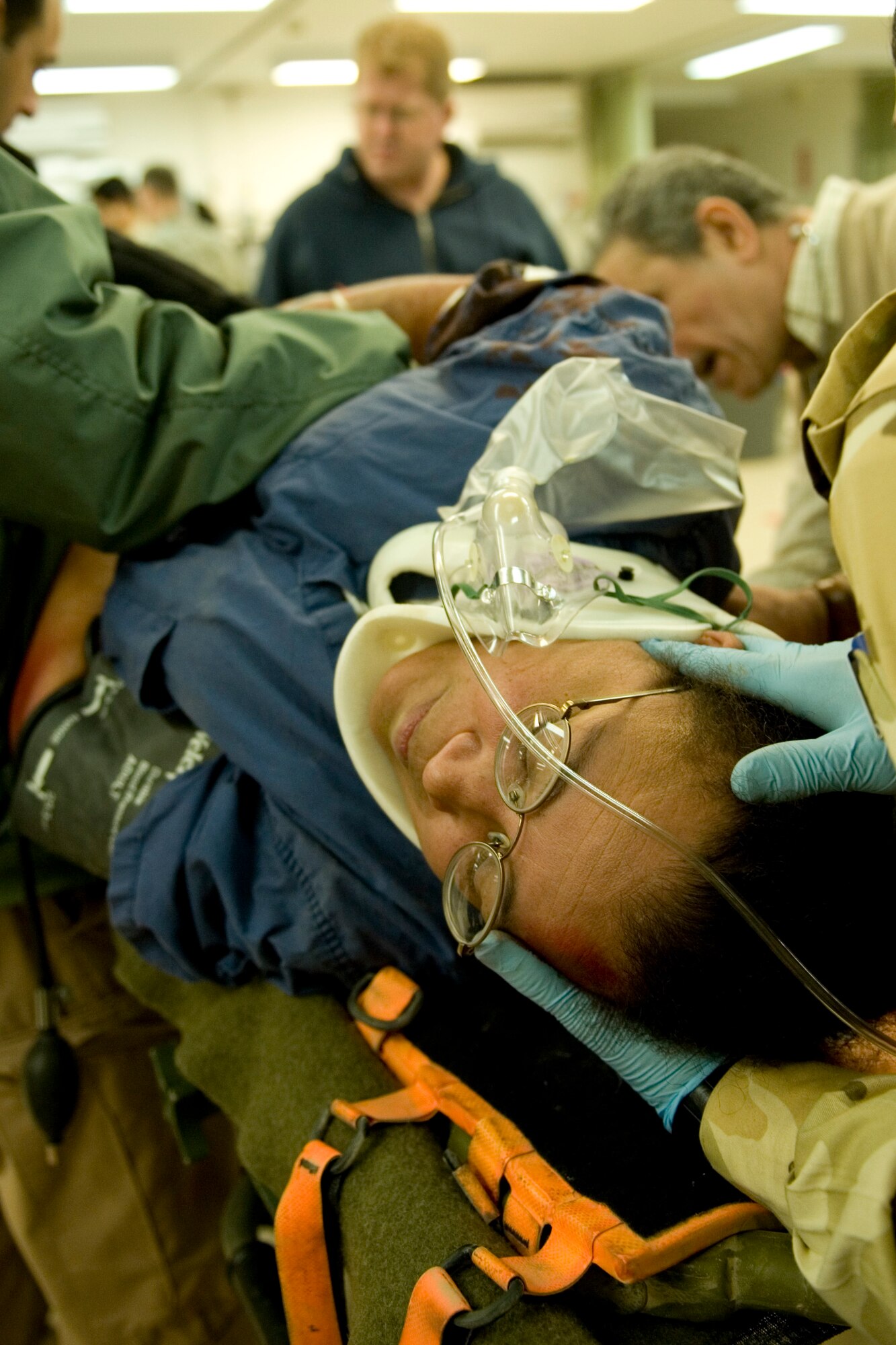 JOINT BASE BALAD, Iraq -- Iraqi medics hold up a mock trauma patient while an instructor explains what areas to check for internal injuries during a medical exercise Feb. 9. The training was part of a first responder workshop held for Iraqi medics to help develop skills to treat trauma patients. (U.S. Air Force photo by Staff Sgt. Levi Riendeau)