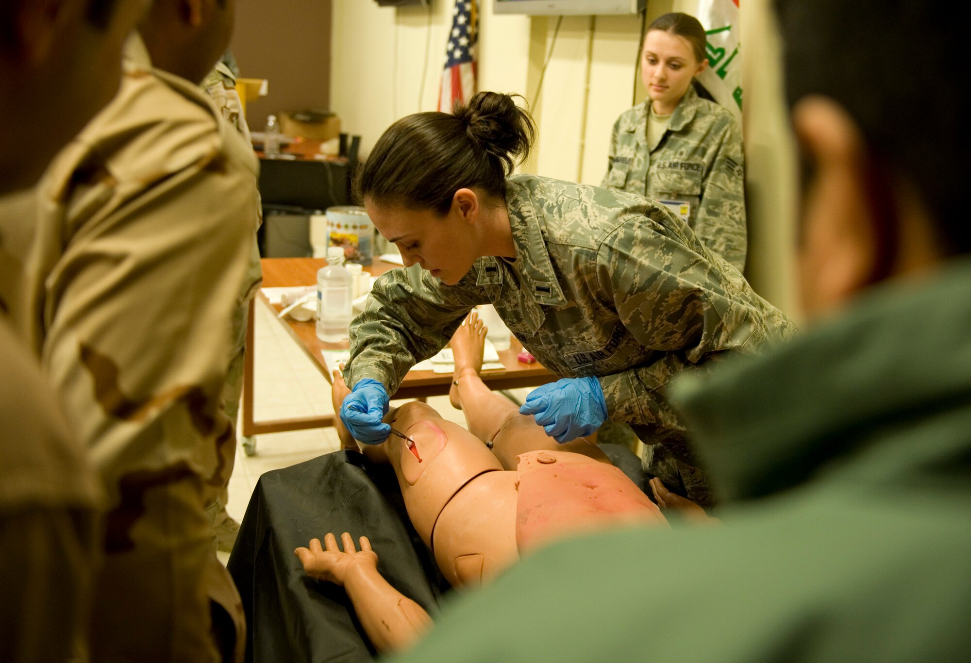 JOINT BASE BALAD, Iraq -- U.S. Air Force 1st Lt. Stephanie Allen, 332nd Expeditionary Medical Group staff nurse, teaches Iraqi medics wound care Feb. 8. The training was part of a first responder workshop held for Iraqi medics to help develop skills to treat trauma patients. Lieutenant Allen is originally from Knoxville, Tenn., and is deployed from Lackland Air Force Base, Texas. (U.S. Air Force photo by Staff Sgt. Levi Riendeau)
