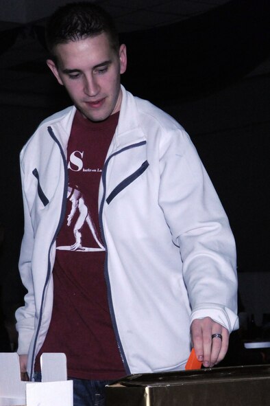 An Incirlik Airman votes for his favorite locally-produced Super Bowl commercial at the finale of the Incirlik Super Bowl commercial contest, Feb. 7, 2011, at the consolidated club at Incirlik Air Base, Turkey. The event was held in conjunction with the Super Bowl XLV screening event.  Attendees had the opportunity to view and vote for their favorite locally-produced commercial. The first place winner received $10,000 in quality-of-life funds for the unit. (U.S. Air Force photo by Master Sgt. James Law/Released)