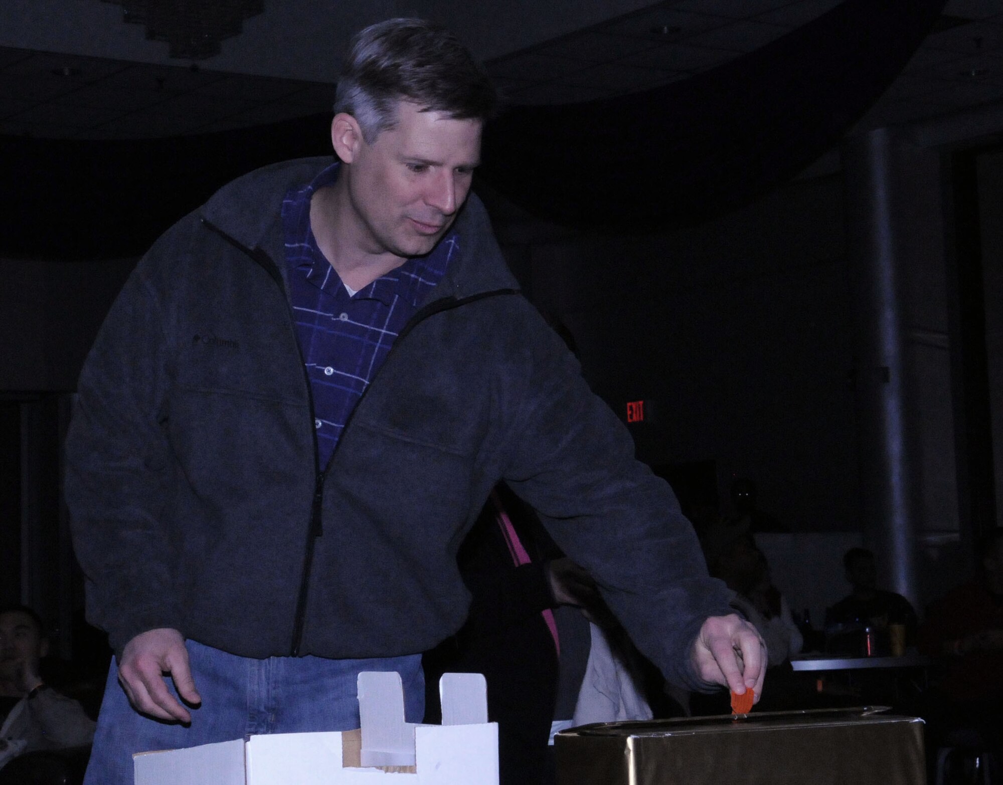 Lt. Col. Bryan Wolford, the 39th Operations Squadron commander, votes for his favorite locally-produced Super Bowl commercial at the finale of the Incirlik Super Bowl commercial contest, Feb. 7, 2011, at the consolidated club at Incirlik Air Base, Turkey. The event was held in conjunction with the Super Bowl XLV screening event.  Attendees had the opportunity to view and vote for their favorite locally-produced commercial. The video submission from the 39th OS took first place in the contest and unit received $10,000 in quality-of-life funds. The second place winner, the 39th Communication Squadron, was awarded $6,000 in quality-of-life funds, and the third place winner, the 39th Security Forces Squadron, won $4,000 in quality-of-life funds.  (U.S. Air Force photo by Master Sgt. James Law/Released)