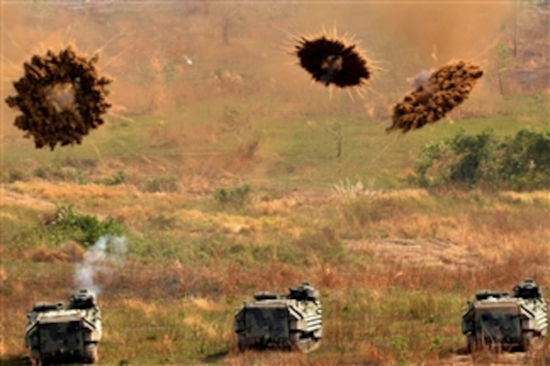 U.S. Marines in amphibious assault vehicles fire smoke grenades at a training range in Ban Chan Krem, Thailand, on Feb. 11, 2011.  The Marines are assigned to Combat Assault Battalion, Ground Combat Element, 3rd Marine Expeditionary Brigade Forward, 3rd Marine Expeditionary Force.  