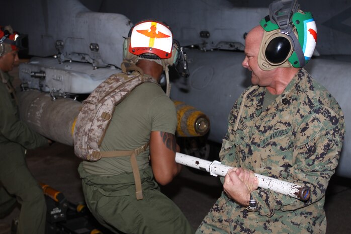Sgt. Maj. Eric J. Seward, sergeant major of 1st Marine Air Wing, III Marine Expeditionary Force, loads highly explosive ordnance onto an F/A-18 Hornet here Feb. 16 in support of Cobra Gold 2011. Cobra Gold is a regularly scheduled exercise that demonstrates joint and multinational capabilities and improves interoperability between the United States and Thailand.