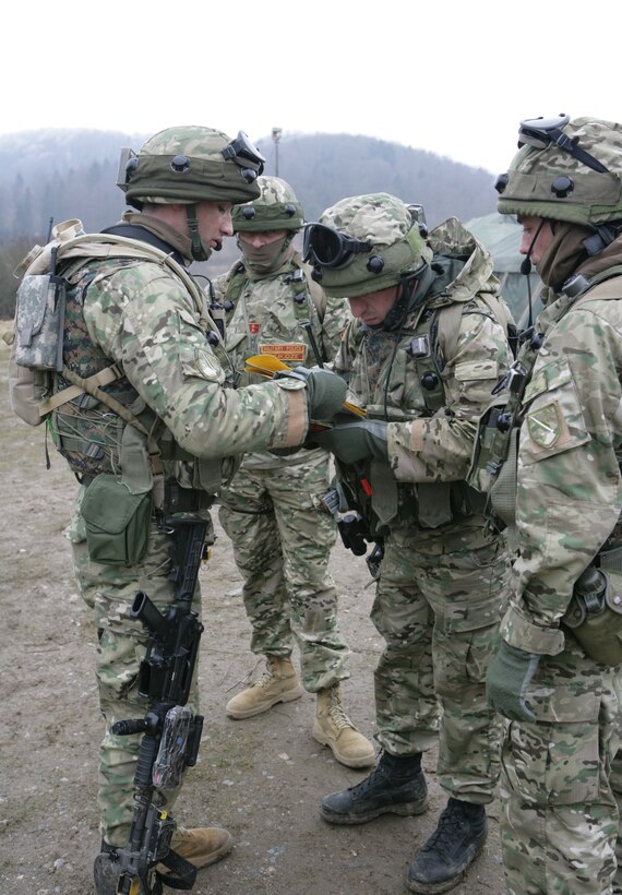 Georgian soldiers assigned to the 33rd Light Infantry Battalion orient their maps and check their gear prior to stepping off on a training patrol at the Joint Multinational Training Center, here. The soldiers are participating in the Georgia Deployment Program- Mission Readiness Exercise, where a majority of the Marines serving as observer/controllers were from 3rd Bn, 7th Marine Regiment, mentoring the 33rd LIB before they head to Afghanistan this spring.