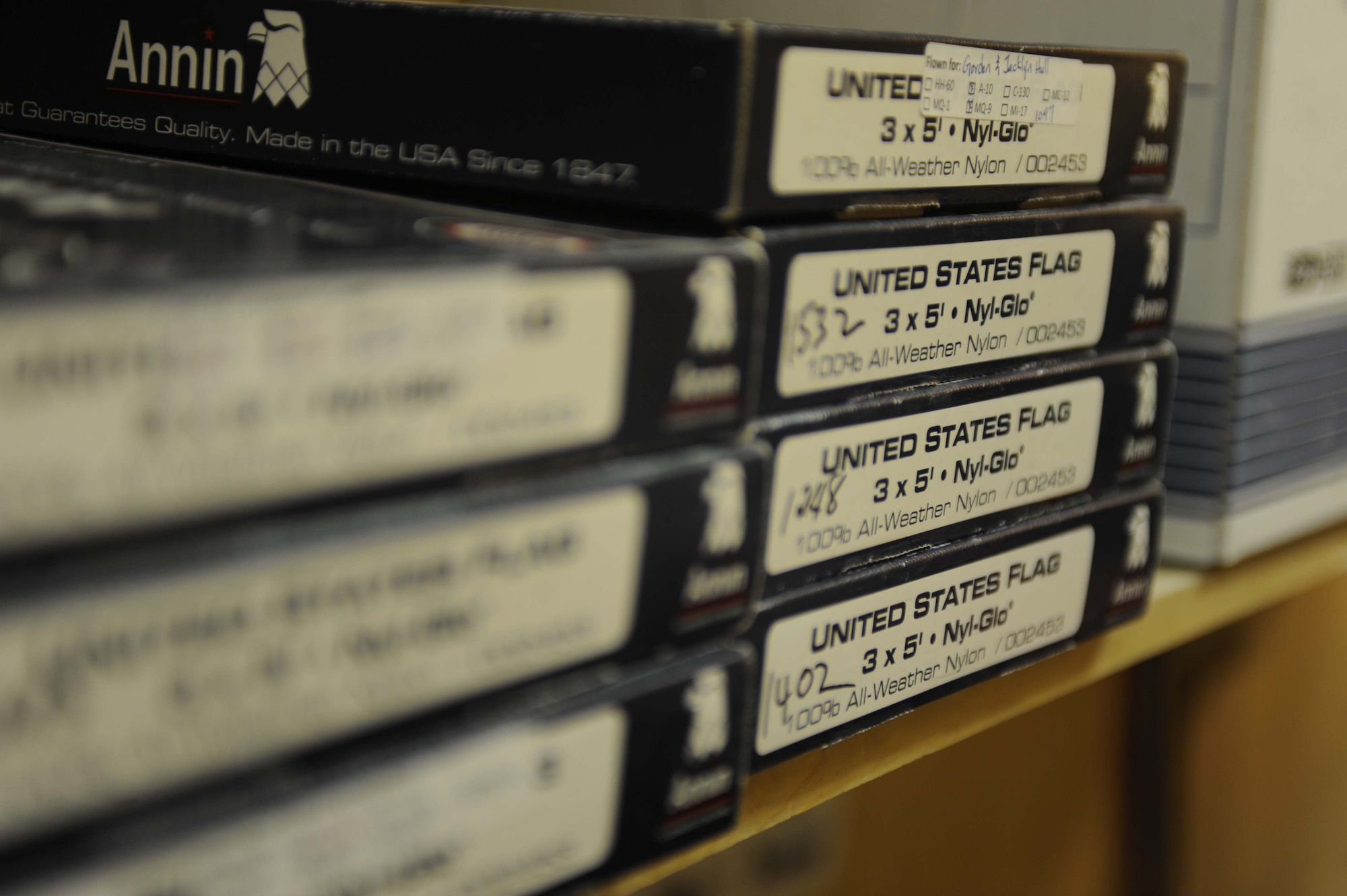 Boxes of American flags line the shelves of Airman 1st Class Joshua Williams' office on Feb. 12, 2011, at Kandahar Airfield, Afghanistan. In addition to his responsibilities as administrative assistant for the commander of the Operations Support Flight, Airman Williams tracks the flag flying program, which flew more than 3,000 flags in the past six months. (U.S. Air Force photo/ Tech. Sgt. Emily F. Alley)