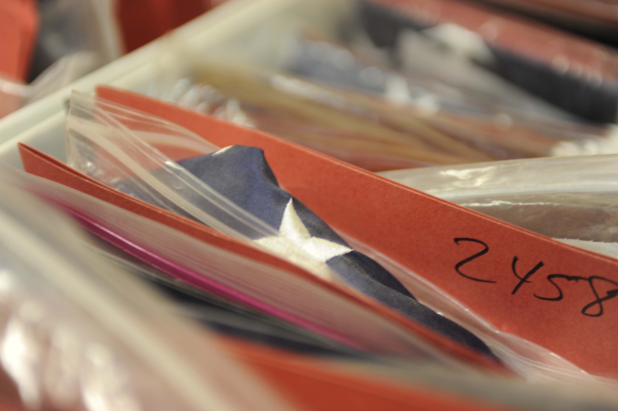 Flags are packed tightly in boxes waiting to be flown on 451st AEW aircraft on Feb. 12, 2011, at Kandahar Airfield, Afghanistan. Flags from all countries, sports teams, schools and more may be flown as part of the 451st AEW flag flying program, but American flags are by far the most common requested. The program is free, but the requester must supply his or her own flag. (U.S. Air Force photo/ Tech. Sgt. Emily F. Alley