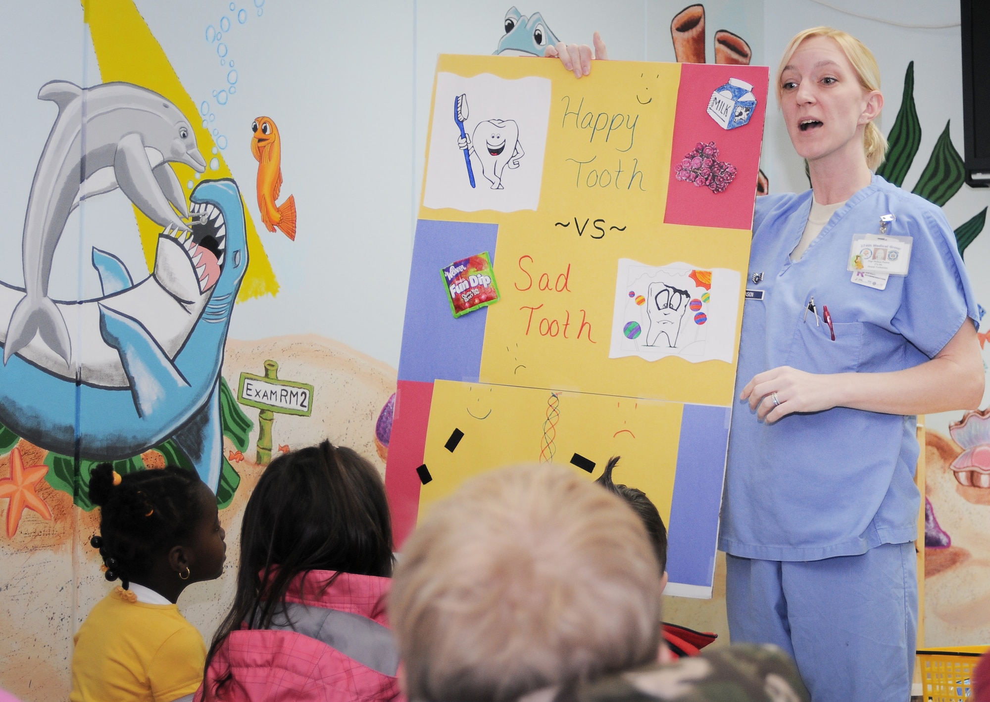 YOKOTA AIR BASE, Japan -- Staff Sgt. Melissa Pasion, 374th Dental Squadron dental assistant, gives a presentation to the kindergarten students on the good and bad practices of dental hygiene here Feb. 16. Kindergarten students from Joan K. Mendel Elementary School and Faith Kingdom Academy International from Fussa City, Japan, visited the Dental Clinic as part of National Children's Dental Health Month. (U.S. Air Force Photo/Airman John Partlow)