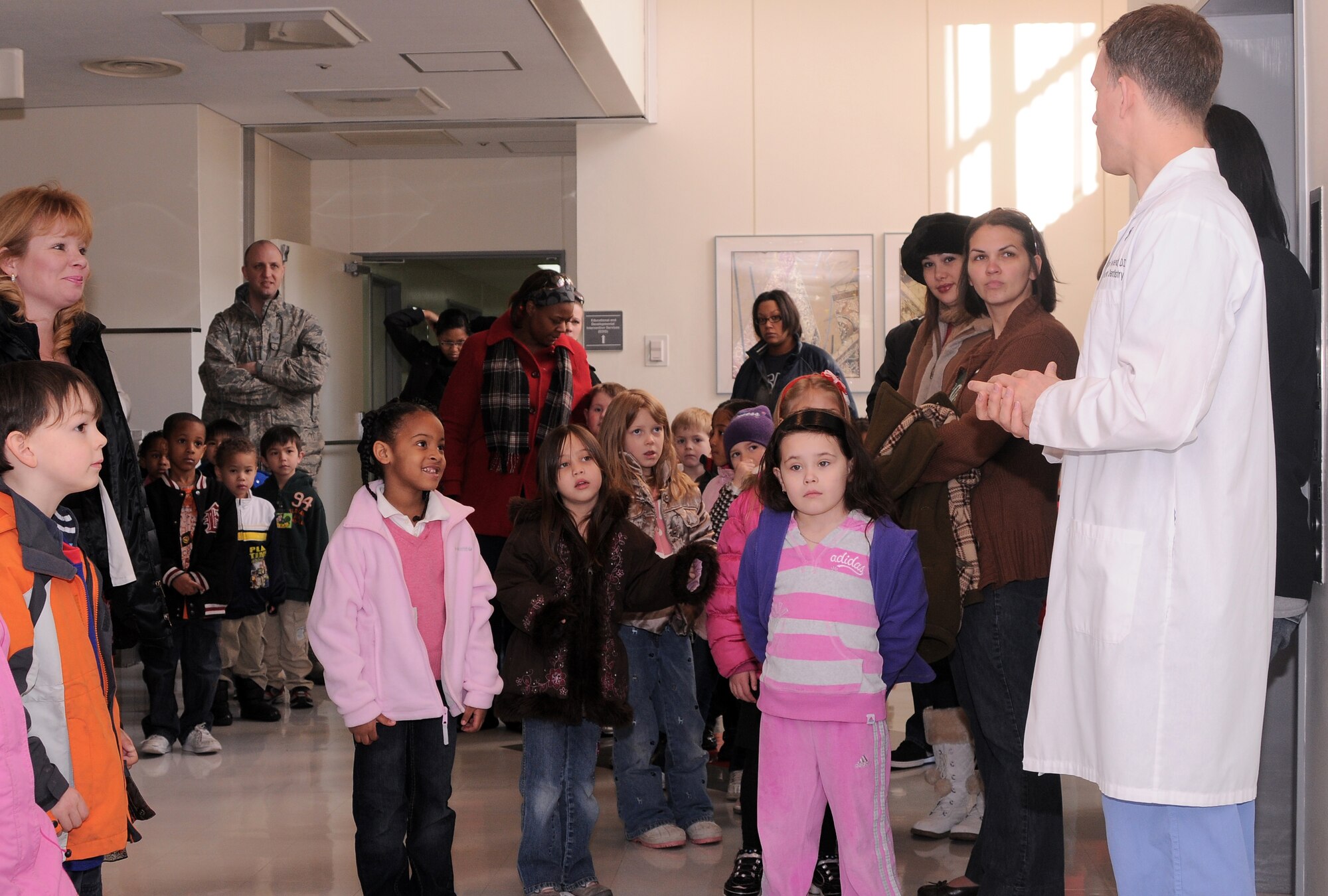 YOKOTA AIR BASE, Japan -- Maj. Michael Townsend, 374th Dental Squadron pediatric dentist (right), welcomes the kindergarten students from Joan K. Mendel Elementary School to the Dental Clinic here Feb. 16. The students visited the Dental Clinic to learn more about dentistry during National Children's Dental Health Month. (U.S. Air Force Photo/Airman John Partlow)