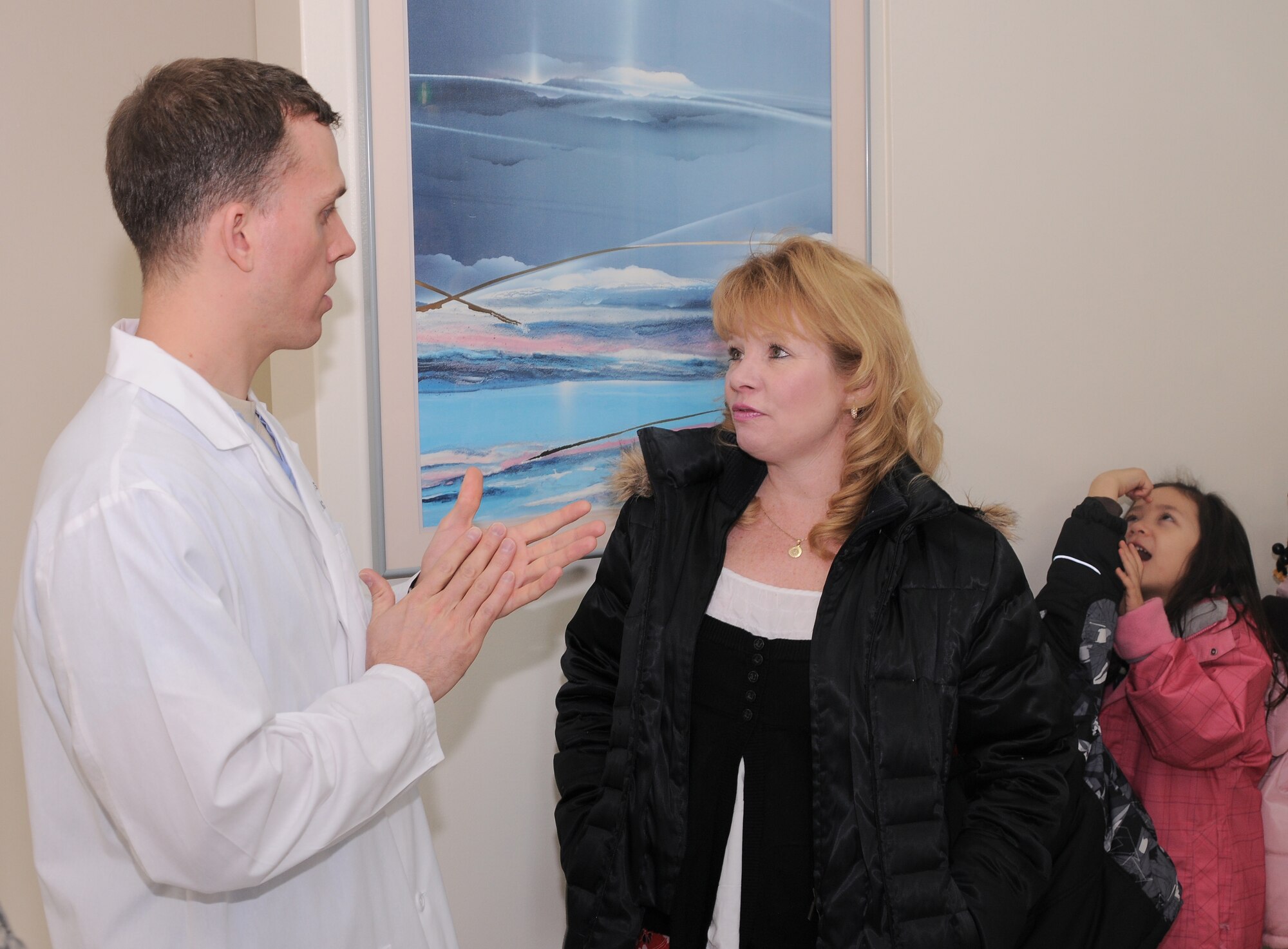 YOKOTA AIR BASE, Japan -- Maj. Michael Townsend, 374th Dental Squadron pediatric dentist (left), explains to Karen Comp, Joan K. Mendel Elementary School kindergarten teacher, what the students would learn at each of the four dental demonstration stations here Feb. 16. Staff members from the 374th DS invited the kindergarten students to tour the facility as part of National Children's Dental Health Month. (U.S. Air Force Photo/Airman John Partlow)
