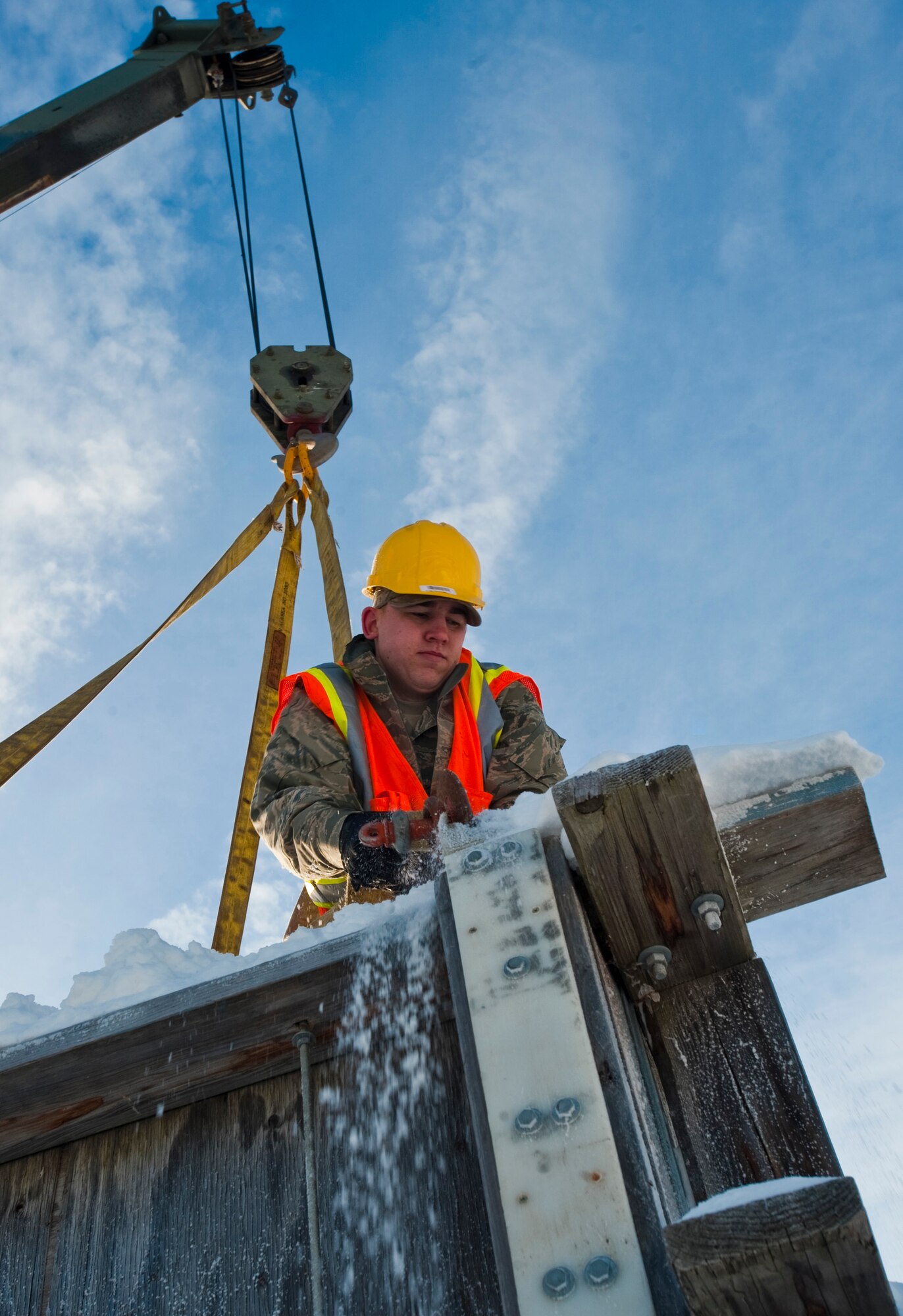 ANCHORAGE, Alaska -- Airman 1st Class Eric Hansen, 773rd Civil Engineer Group from Joint Base Elmendorf-Richardson, straps a box to a crane Feb. 17. Several members of the 773rd CEG spent the day in Anchorage forming snow blocks that will be used for the ice sculpture competition during this year's Fur Rendezvous Festival. Fur Rondy is an annual winter festival held in Anchorage dating to the mid-1930s. This year's Fur Rondy will be from Feb. 25 through March 6. (Air Force photo by Airman 1st Class Christopher Gross)