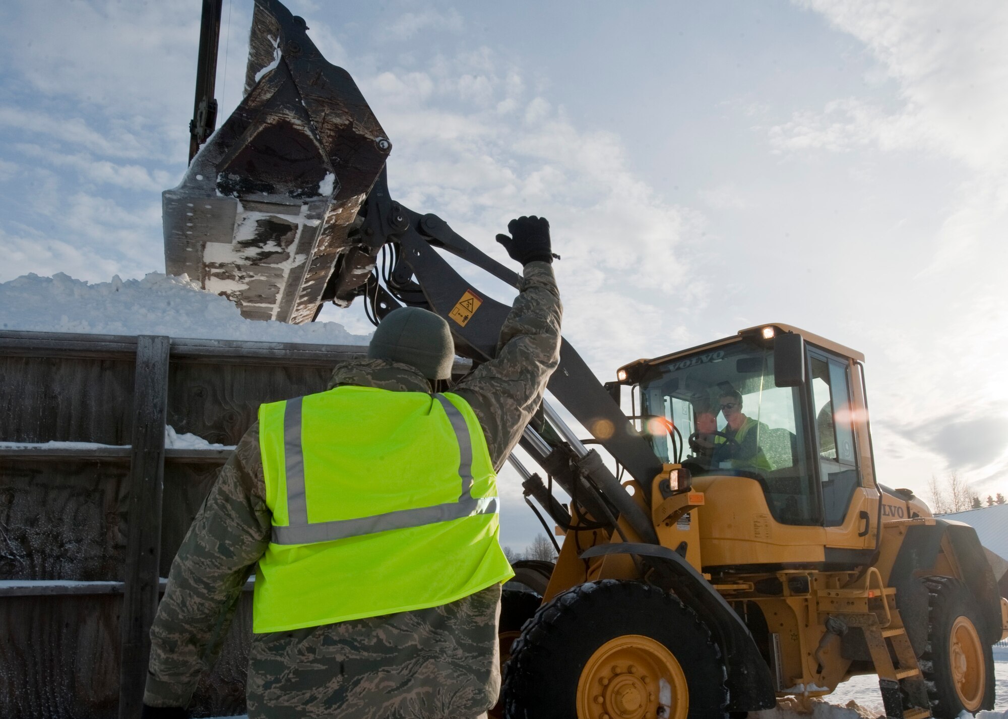 ANCHORAGE, Alaska -- Tech. Sgt. Damion Parris directs Airman 1st Class Tyler Jerome as he compacts snow in a form Feb. 17, both are from the 773rd Civil Engineer Group from Joint Base Elmendorf-Richardson. Several members of the 773rd CEG spent the day in Anchorage forming snow blocks that will be used for the ice sculpture competition during this year's Fur Rendezvous Festival. Fur Rondy is an annual winter festival held in Anchorage dating to the mid-1930s. This year's Fur Rondy will be from Feb. 25 through March 6. (Air Force photo by Airman 1st Class Christopher Gross)