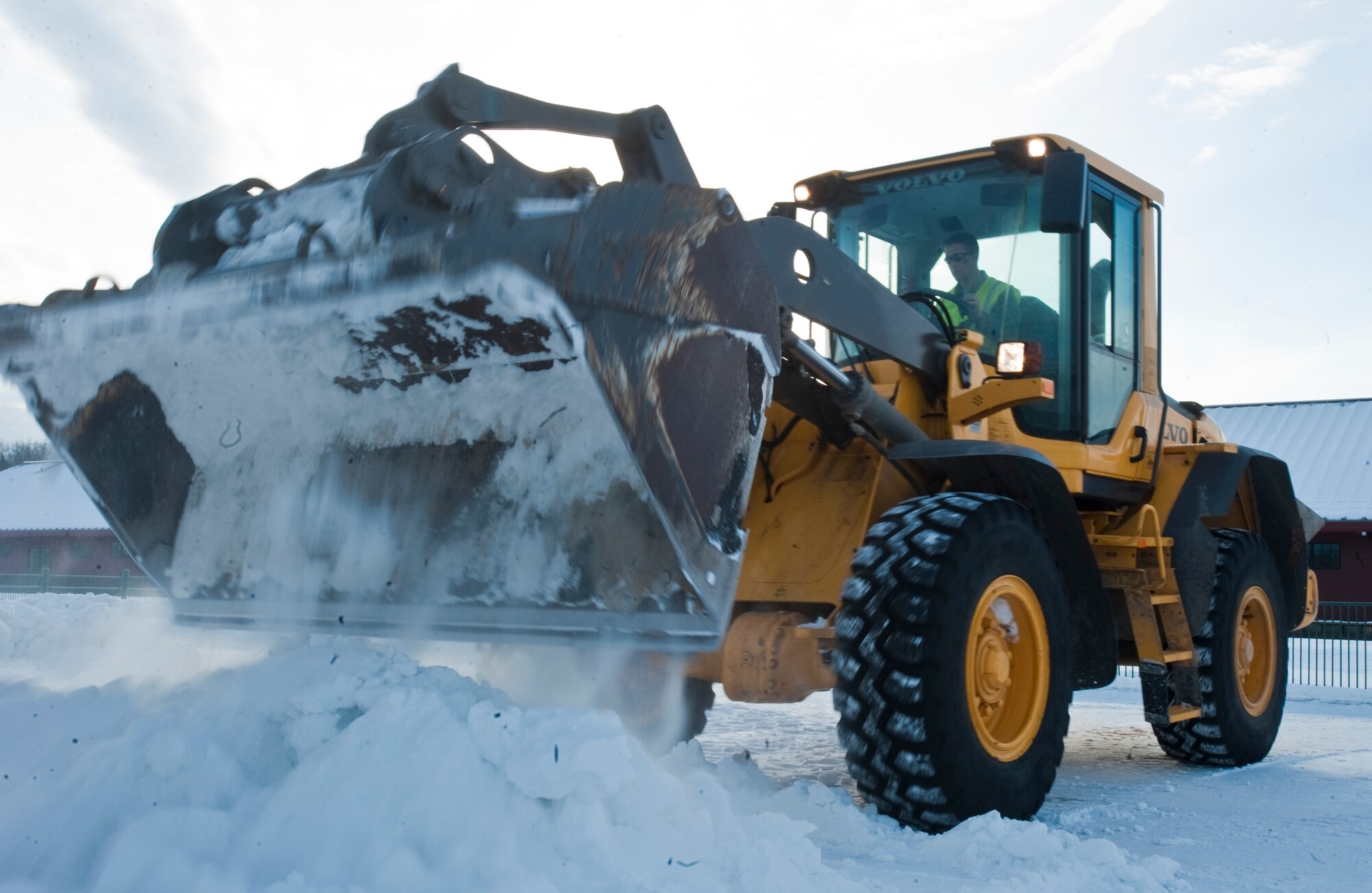 ANCHORAGE, Alaska -- Airman 1st Class Tyler Jerome, 773rd Civil Engineer Group from Joint Base Elmendorf-Richardson, dumps a load of snow Feb. 17. Several members of the 773rd CEG spent the day in Anchorage forming snow blocks that will be used for the ice sculpture competition during this year's Fur Rendezvous Festival. Fur Rondy is an annual winter festival held in Anchorage dating to the mid-1930s. This year's Fur Rondy will be from Feb. 25 through March 6. (Air Force photo by Airman 1st Class Christopher Gross)