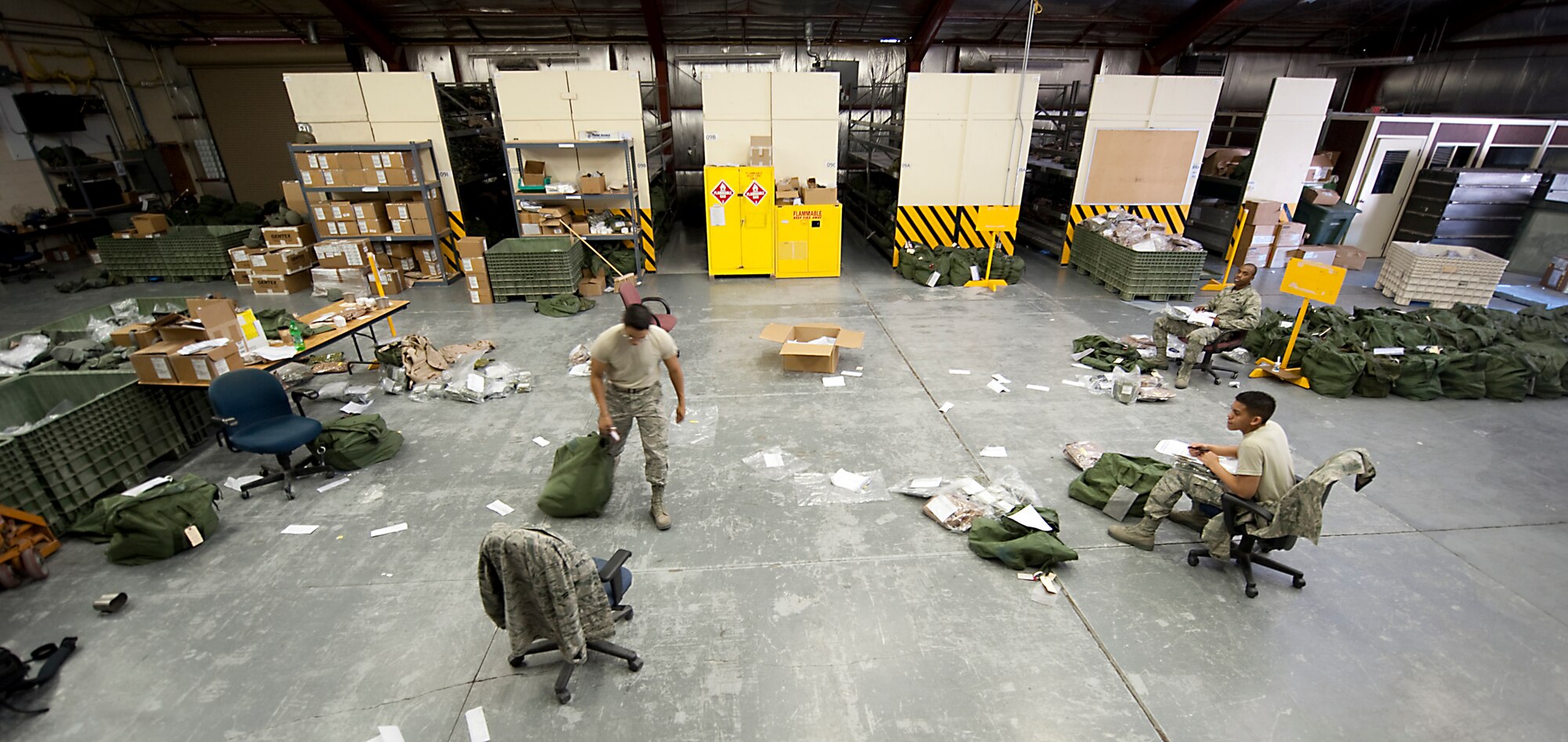 HOLLOMAN AIR FORCE BASE, N.M. -- Airmen from the 49th Logistics Readiness Squadron unpack mobility bags used in the previous operational readiness exercise Feb. 15, 2011. Airmen from the 49th LRS inspect and issue individual protective equipment needed for Airmen tasked to deploy in an ORE or real-world deployment. (U.S. Air Force photo by Senior Airman Veronica Stamps/Released)