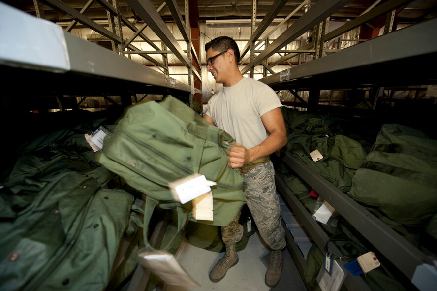 HOLLOMAN AIR FORCE BASE, N.M. -- Airman 1st Class Abraham Reyes, 49th Logistics Readiness Squadron, stacks mobility bags, Feb. 15, 2011, onto alphabetically ordered shelves. After each mobility bag has been inspected for accuracy, they are placed either in chalk order for Airmen processing in the next operational readiness exercise or stacked onto shelves for those who may receive a last minute tasking. (U.S. Air Force photo by Senior Airman Veronica Stamps/Released)