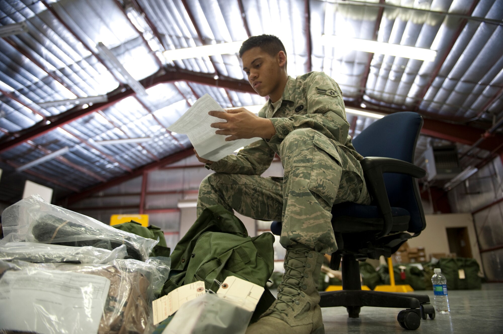 HOLLOMAN AIR FORCE BASE, N.M. -- In preparation for the upcoming operational readiness exercise, Airman 1st Class Darryl Carter, 49th Logistics Readiness Squadron, checks sizing sheets against mobility bag contents, Feb 15, 2011, for Airmen tasked to deploy. Airmen from the 49 LRS inspect and issue individual protective equipment Airmen need during deployments. (U.S. Air Force photo by Senior Airman Veronica Stamps/Released)