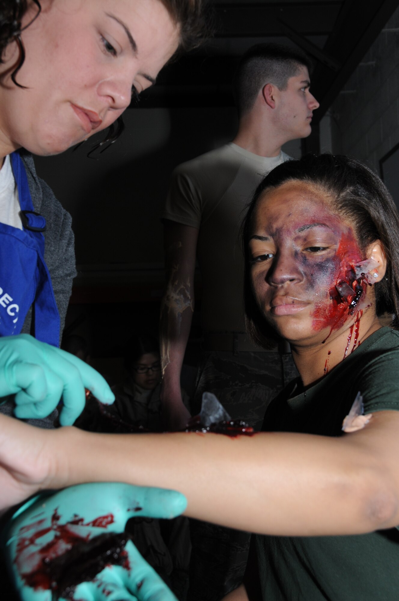 Staff Sgt. Cassandra Day, 81st Dental Squadron applies moulage to Airman 1st Class Katrice Jones 336th Training Squadron student. Airman Jones played a victim in today’s exercise in which Keesler responded to a mid-air collision of two Blue Angel’s F-18’s.   (U.S. Air Force photo by Kemberly Groue)