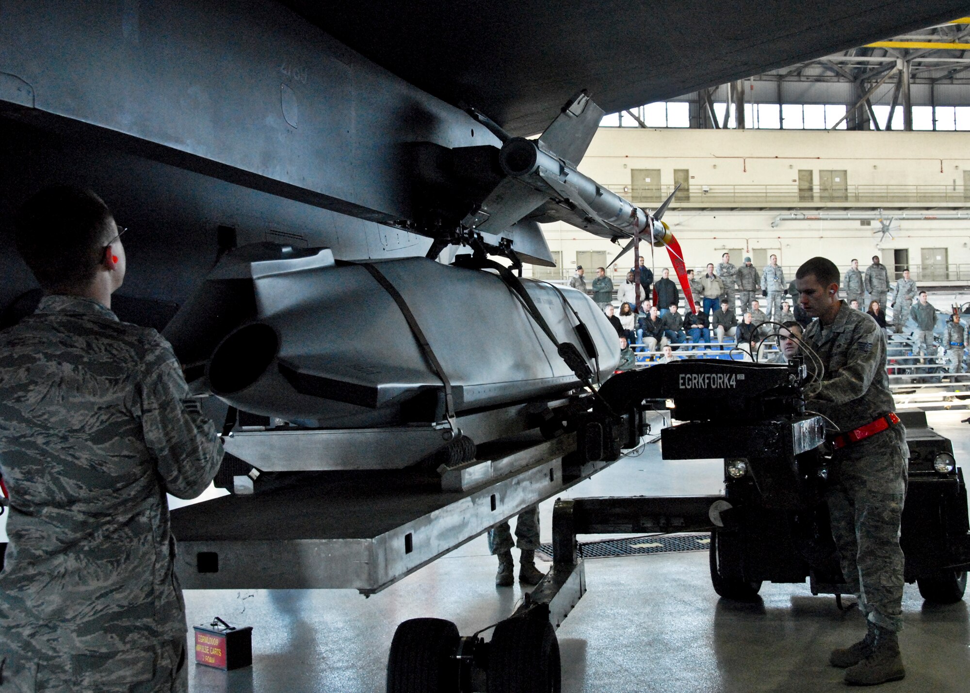 Staff Sgt. Anthony Bagent, 46th Aircraft Maintenance Squadron, works with his fellow red teammates at the Load Crew of the Year competition Feb. 11 at Eglin Air Force Base, Fla. Teams competed against each other to see who could properly load munitions on an F-16 quickest with the fewest errors. Winners will be announced at the annual award banquet March 4.  (U.S. Air Force photo/Sachel Seabrook)