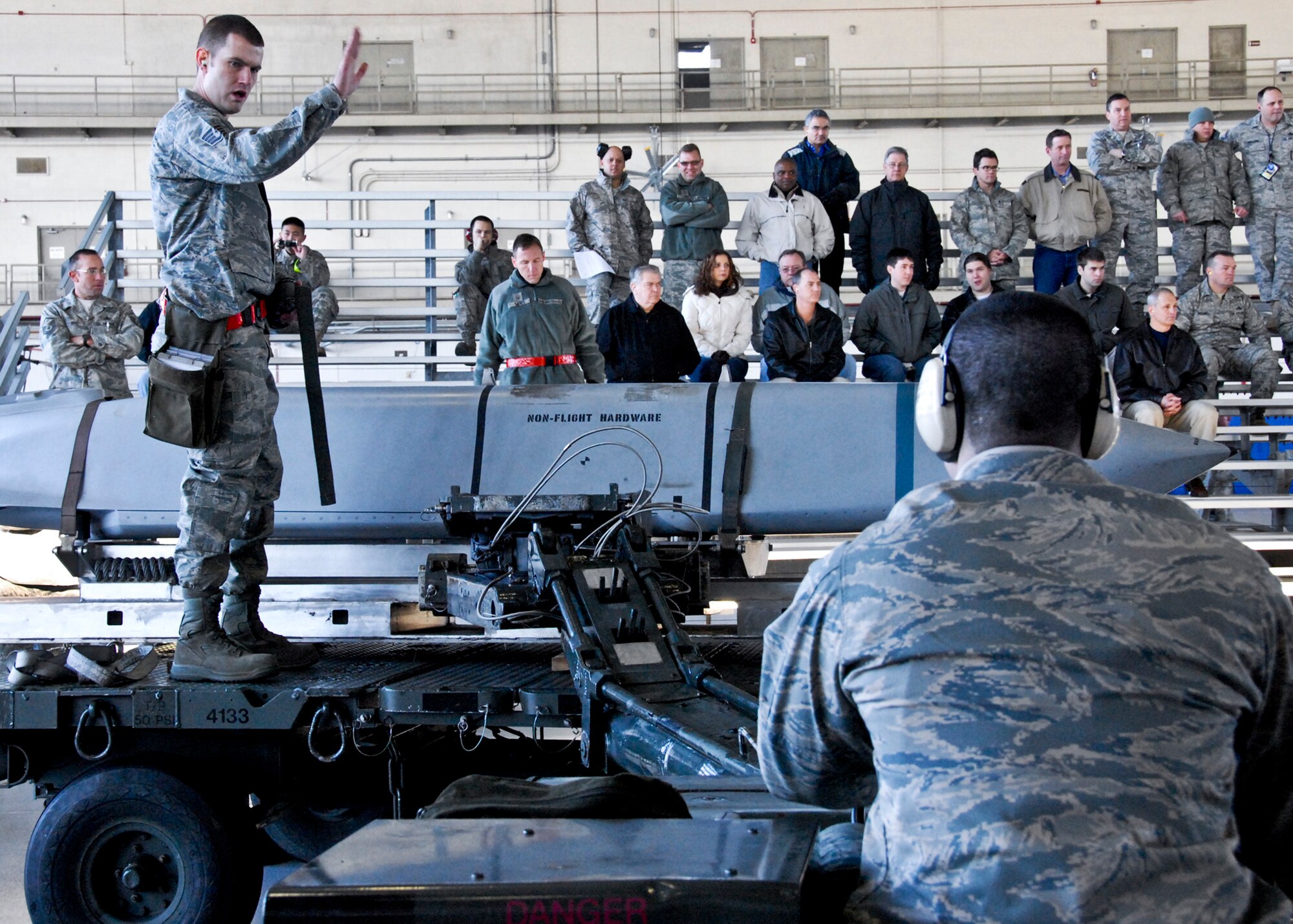 Staff Sgt. Anthony Bagent, 46th Aircraft Maintenance Squadron, signals his teammate to stop at the Load Crew of the Year competition Feb. 11 at Eglin. Teams competed against each other to see who could properly load munitions on an F-16 quickest with the fewest errors. Winners will be announced at the annual award banquet March 4.  (U.S. Air Force photo/Sachel Seabrook)