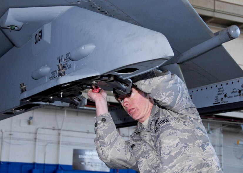 Senior Airman Krystal Orth, 46th Aircraft Maintenance Squadron, makes sure everything is secure on her team’s aircraft at the Load Crew of the Year competition Feb. 11 at Eglin. The blue and red teams competed against each other to see who could properly load munitions on an F-16 quickest with the fewest errors.  Winners will be announced at the annual award banquet March 4.  (U.S. Air Force photo/Sachel Seabrook)