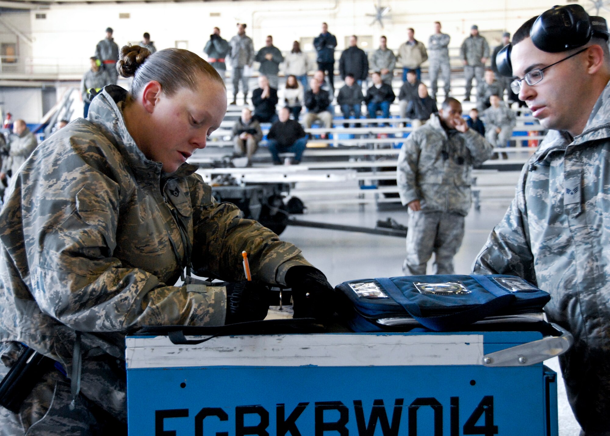 Staff Sgt. Alison Kline and Senior Airman Ryan Corley, 46th Aircraft Maintenance Squadron, take notes for the blue team at the Load Crew of the Year competition Feb. 11 at Eglin. Teams competed against each other to see who could properly load munitions on an F-16 quickest with the fewest errors.  Winners will be announced at the annual award banquet March 4.  (U.S. Air Force photo/Sachel Seabrook)