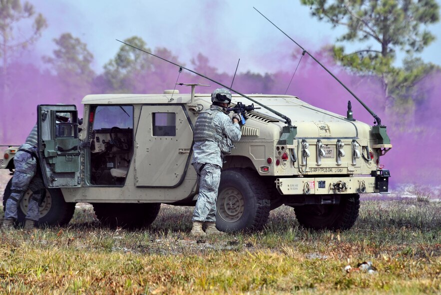 AVON PARK, Fla. -- Members of the 823rd Base Defense Squadron return fire at opposing forces members during joint exercise ATLANTIC STRIKE 11-01 Feb. 16.  Humvee’s provided coverage and rescued any members of the 823rd BDS that were injured or downed during the assault. (U.S. Air Force photo/Airman 1st Class Nicholas Benroth)(RELEASED)