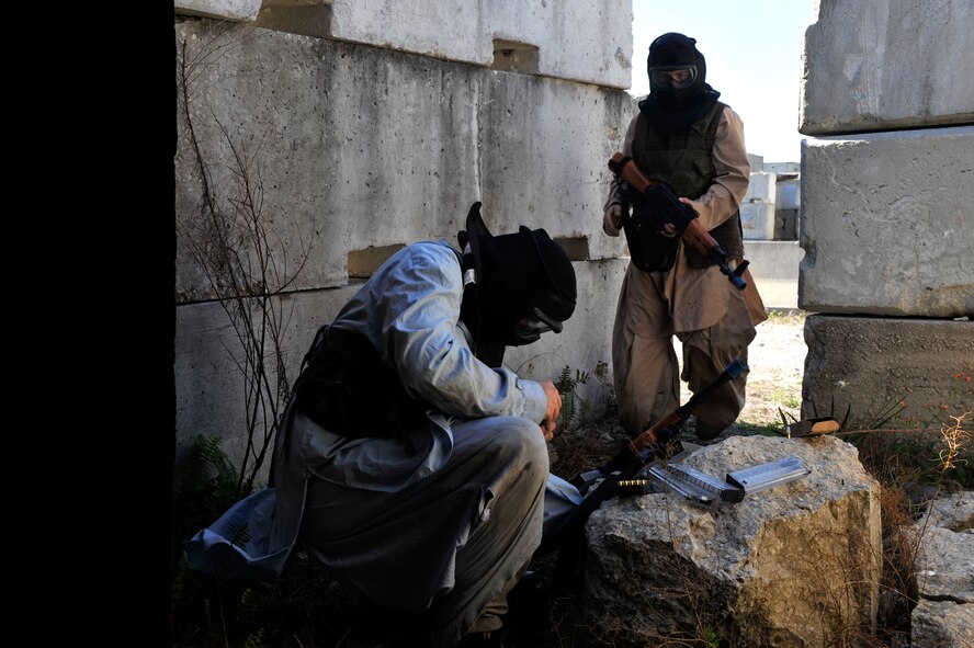 AVON PARK, Fla. -- Opposing forces members reload their weapons as the engage the 823rd Base Defense Squadron members during joint exercise ATLANTIC STRIKE 11-01 Feb. 15. The 823rd BDS used airstrikes and special tactics to take out the opposing forces members. (U.S. Air Force photo/Airman 1st Class Nicholas Benroth)(RELEASED)
