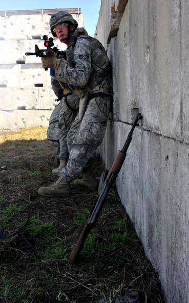 AVON PARK, Fla. -- Senior Airman Joshua Whisenhunt, 823rd Base Defense Squadron watches his squad’s back as they assault a village during joint exercise ATLANTIC STRIKE 11-01 Feb. 15. The squad moved through the village attacking opposing forces and discovering weapons caches as they cleared building. (U.S. Air Force photo/Airman 1st Class Nicholas Benroth)(RELEASED)