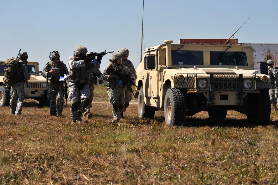 AVON PARK, Fla. -- Members of the 823rd Base Defense Squadron move toward the village as a Humvee provides cover from any enemy fire during joint exercise ATLANTIC STRIKE 11-01 Feb. 15. The rounds used in the exercise were simulation rounds that consisted of bullets filled with blue paint. (U.S. Air Force photo/Airman 1st Class Nicholas Benroth)(RELEASED)
