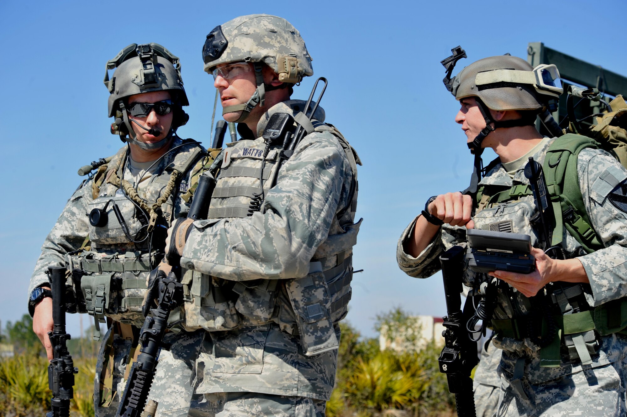 AVON PARK, Fla. -- Staff Sgt. Nicholas Palazzolo and Airman 1st Class Brian Nawrocki, 18 Air Support Operations Group joint terminal attack controllers, brief 2nd Lt. Shane Watts, 823rd Base Defense Squadron flight commander, of their situation as they approach the village during joint exercise ATLANTIC STRIKE 11-01 Feb. 15.   Communicating with the ground commander to coordinate air support is a critical piece of their job. (U.S. Air Force photo/Airman 1st Class Nicholas Benroth)(RELEASED)