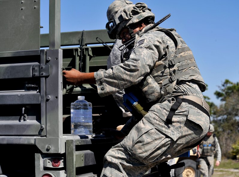 AVON PARK, Fla. -- Senior Airman Steven Smith, 823rd Base Defense Squadron fire team member loads up into the truck with his fellow squad members as they prepare to head into the village during joint exercise ATLANTIC STRIKE 11-01 Feb. 15. The 823rd BDS acted as ground forces to help train the joint terminal attack controllers during the joint exercise. (U.S. Air Force photo/Airman 1st Class Nicholas Benroth)(RELEASED)