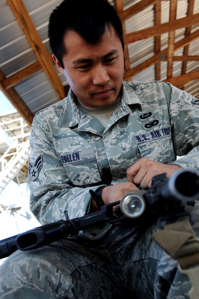 AVON PARK, Fla.-- Senior Airman Michael Edelen, 823rd Base Defense Squadron fire team member, cleans his rifle after finishing one training  scenario during joint exercise ATLANTIC STRIKE11-01  Feb. 15. The 823rd BDS conducted two exercise events per day during the duration of the exercise. (U.S. Air Force photo/Airman 1st Class Benjamin Wiseman)(RELEASED) 