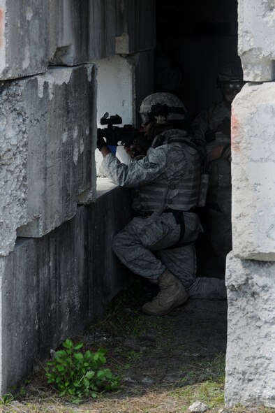 AVON PARK, Fla.-- Senior Airman Bryan Davis, 823rd Base Defense Squadron, lays down cover fire from inside a building during joint exercise ATLANTIC STRIKE 11-01 Feb. 16. The 823rd BDS acted as the forward attack unit to give joint terminal attack controllers from different units and nations a realistic scenario during the exercise. (U.S. Air Force photo/Airman 1st Class Benjamin Wiseman)(RELEASED)