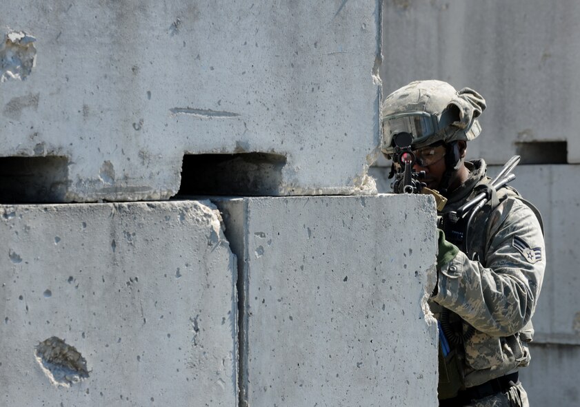 AVON PARK, Fla.-- Senior Airman Steven Smith, 823rd Base Defense Squadron fire team member, aims down his sights during joint exercise ATLANTIC STRIKE 11-01 Feb. 15. The 823rd BDS moved tactically through the mock village to ensure all resisting forces were eliminated during the joint exercise. (U.S. Air Force photo/Airman 1st Class Benjamin Wiseman)(RELEASED)