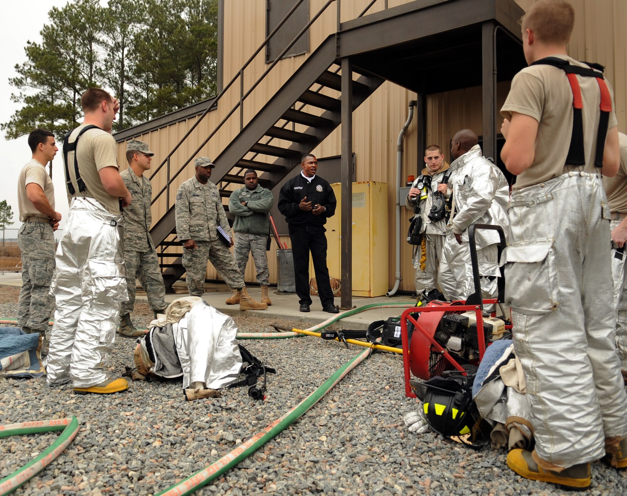 MOODY AIR FORCE BASE, Ga. -- Charlie Johnson, 23rd Civil Engineer Squadron assistant chief of training, talks with firefighters from the 23rd CES about how they performed during a structural exercise Feb. 17. During this discussion, Mr. Johnson reminded the firefighters of safety precautions and explained the importance of taking care of equipment. (U.S. Air Force photo/Airman 1st Class Douglas Ellis)(RELEASED)
