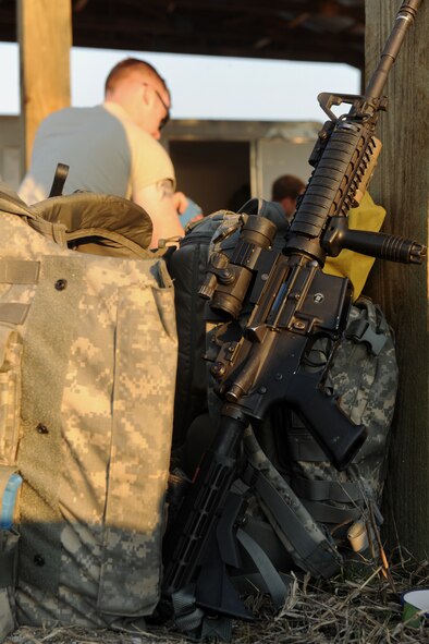 AVON PARK, Fla.-- An M-4 assault rifle sits as members of the 823rd Base Defense Squadron gear up to participate in joint exercise ATLANTIC STRIKE 11-01 Feb. 15. The 823rd BDS acted as a forward attack squad during the exercise and their mission was to clear a mock village of hostile forces. (U.S. Air Force photo/Airman 1st Class Benjamin Wiseman)(RELEASED)