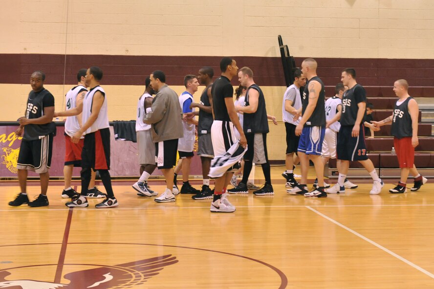 SEYMOUR JOHNSON AIR FORCE BASE, N.C. – The 4th Security Forces Squadron and 4th Medical Group shake hands at the end their intramural basketball game here, Feb. 16, 2011. Shaking hands displays good sportsmanship. The 4th Security Forces Squadron beat the 4th Medical Group, 51 to 57. (U.S. Air Force photo/Senior Airman Whitney Lambert) (RELEASED)