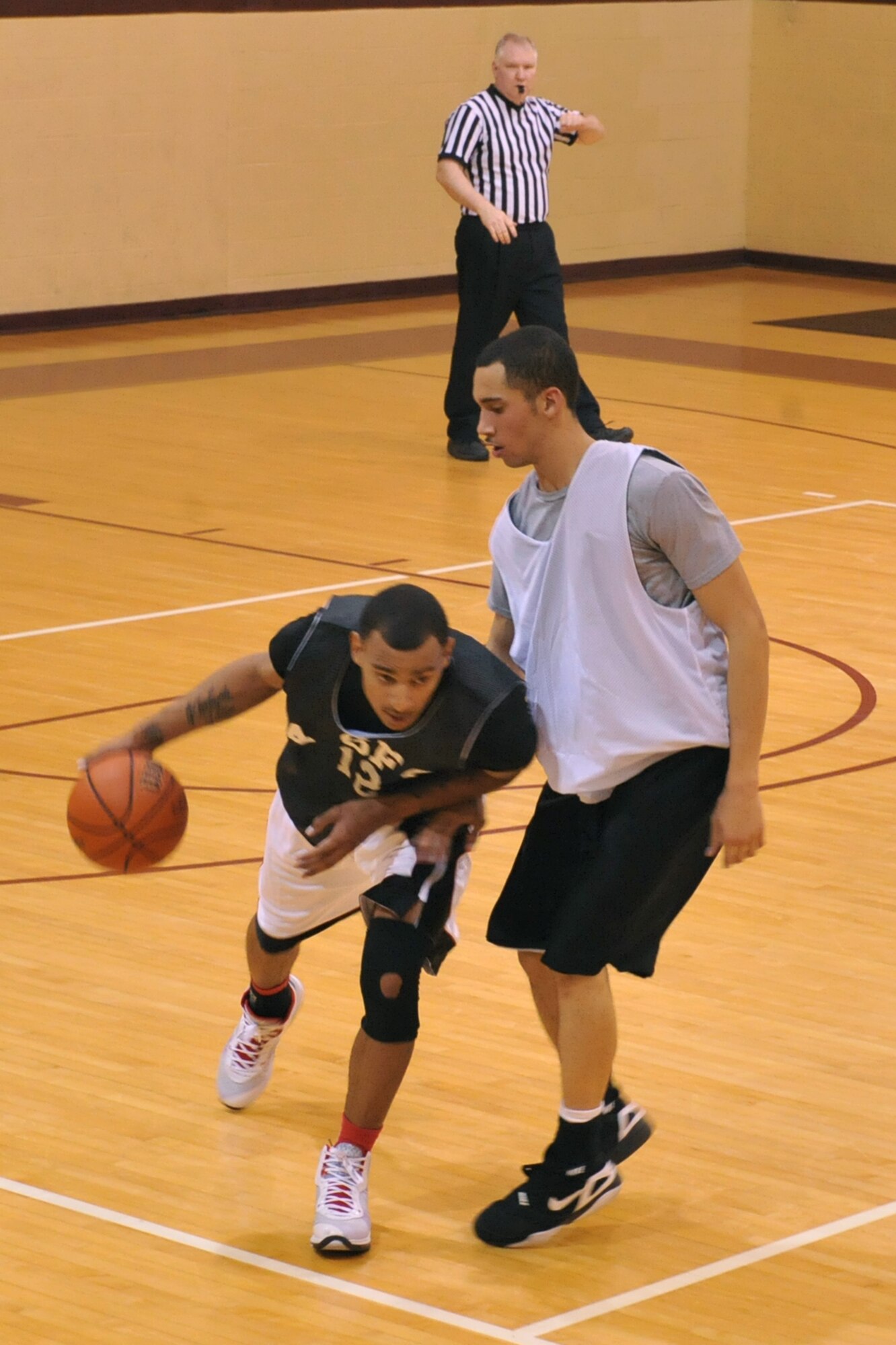 SEYMOUR JOHNSON AIR FORCE BASE, N.C. – Senior Airman Malcolm Stephens plays offense against Airman 1st Class Xavier Morris during an intramural basketball game here, Feb. 16, 2011. The 4th Force Support Squadron fitness center staff hosts intramural basketball games played Monday through Thursday starting at 6 p.m. Airman Stephens is from Las Vegas and Airman Morris is from Columbus. (U.S. Air Force photo/Senior Airman Whitney Lambert) (RELEASED)