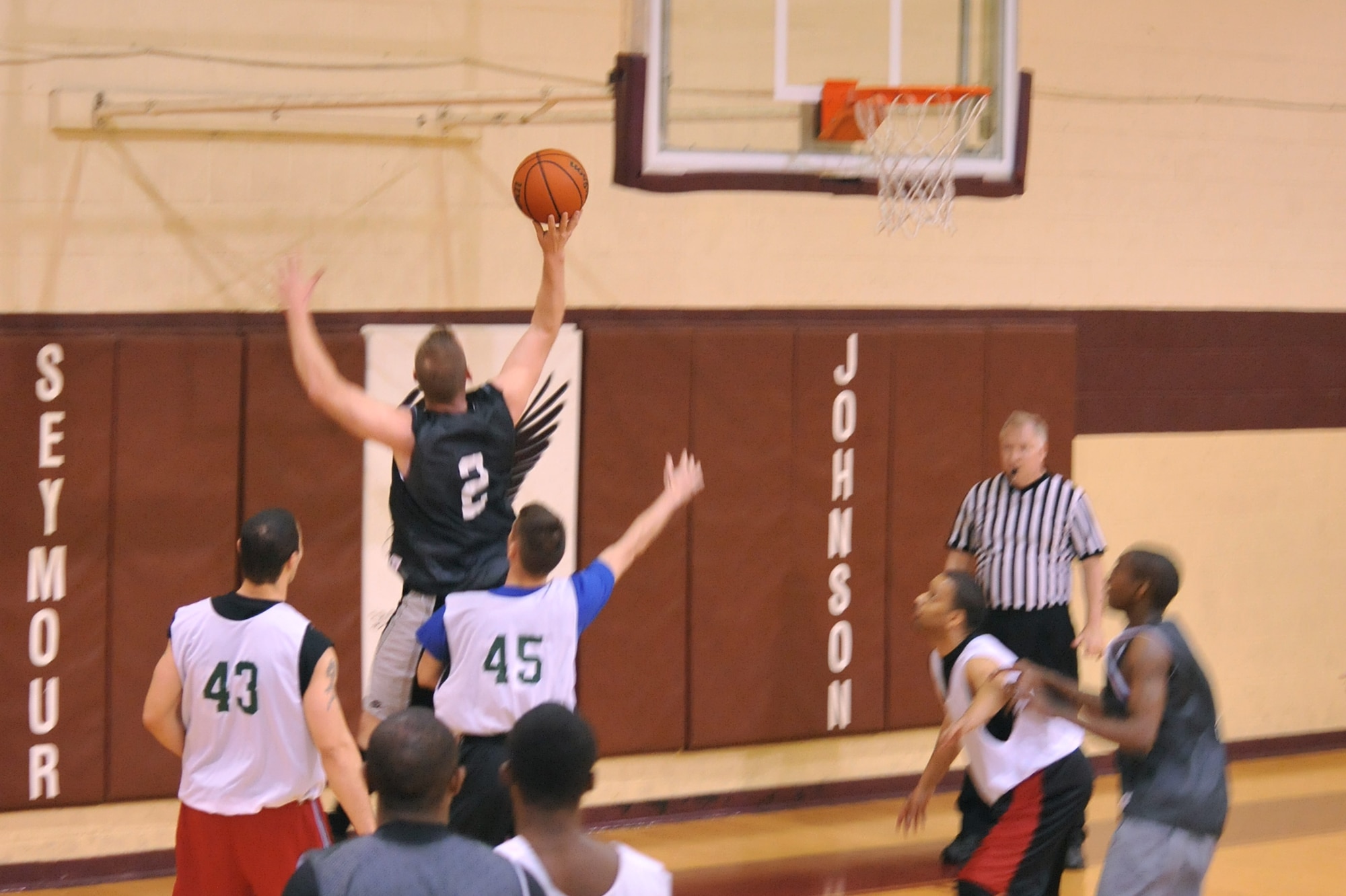 SEYMOUR JOHNSON AIR FORCE BASE, N.C. – Tech. Sgt. Elmer Smith goes up for a bank shot during an intramural basketball game here, Feb. 16, 2011. A bank shot is when using the backboard as a deflecting tool that directs the basketball into the hoop. Sergeant Smith native of Yazoo City, Miss. (U.S. Air Force photo/Senior Airman Whitney Lambert) (RELEASED)