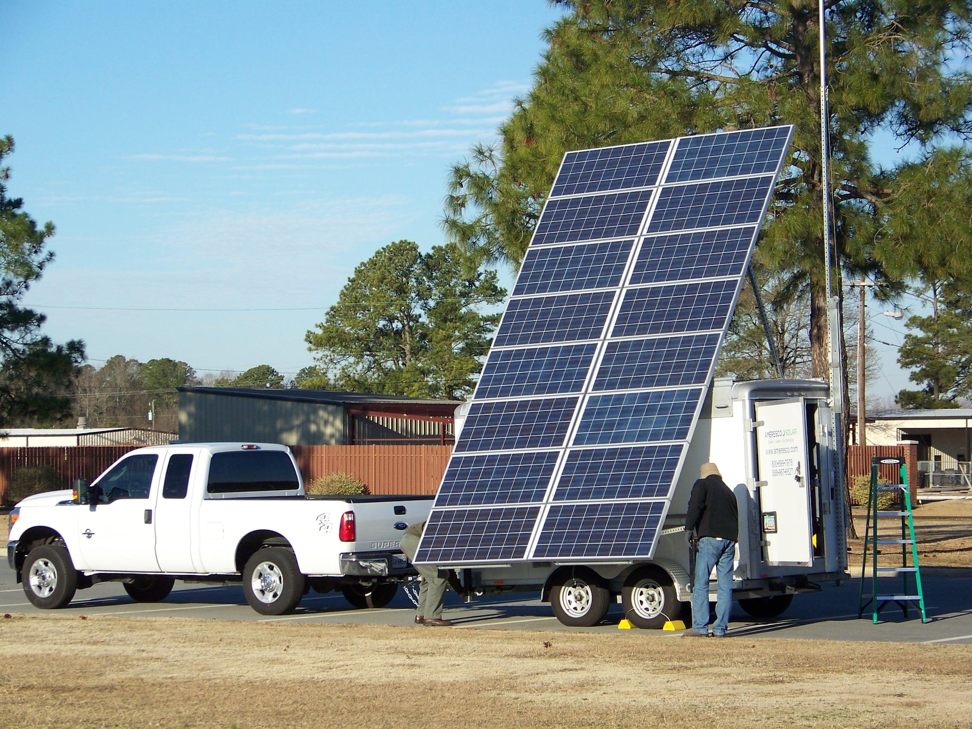 SEYMOUR JOHNSON AIR FORCE BASE, N.C. –  An Ameresco employee sets up a Transportable Renewable Energy eXchange so he can showcase the system’s capabilities to members of the 4th Civil Engineer Squadron Power Pro Shop. The T-REX is essentially a trailer equipped with a solar power array, wind generator and liquid propane powered electric generator capable of delivering 5.5KW of power.  (U.S. Air Force photo/Matthew Latham) (RELEASED)