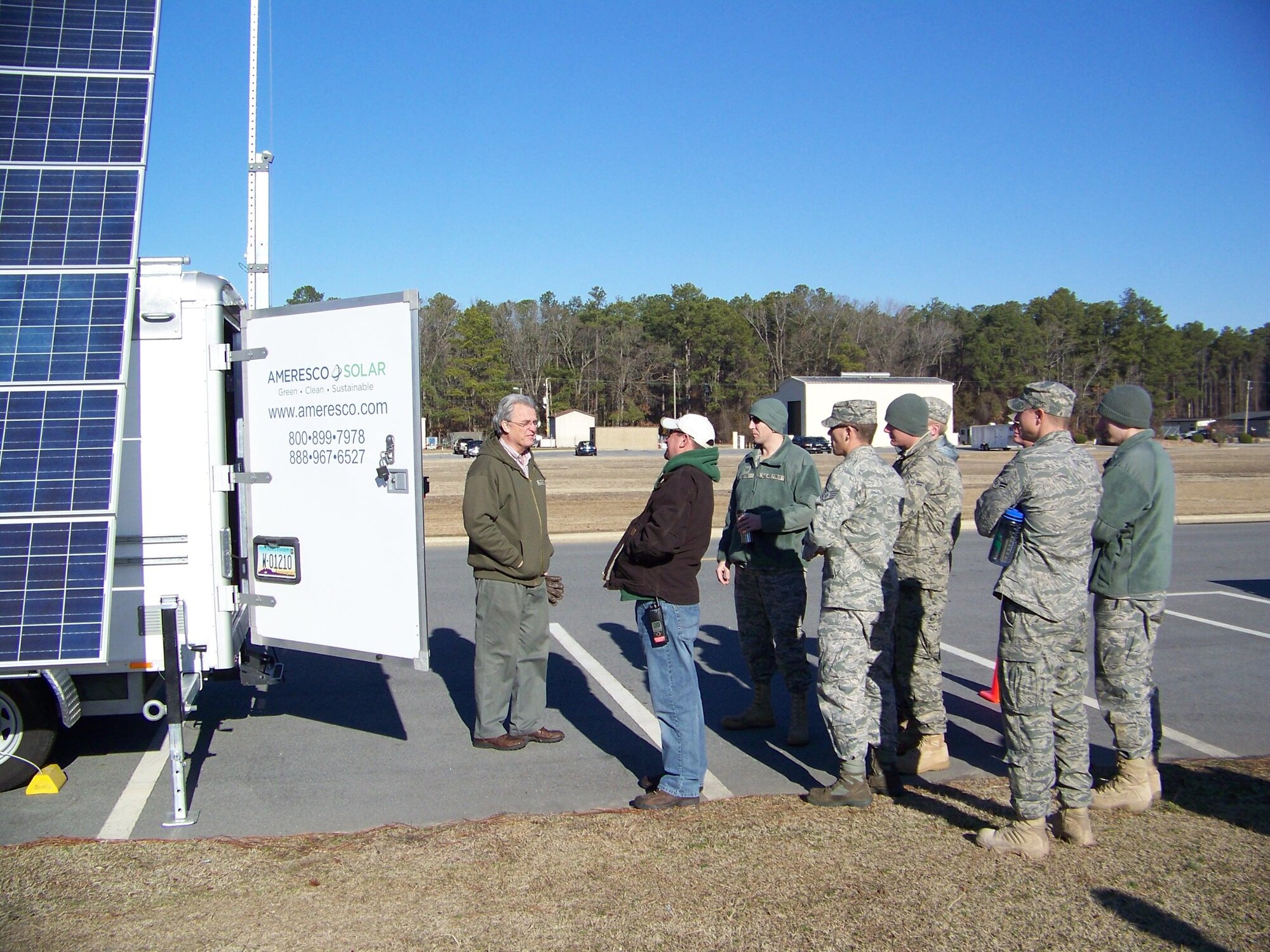 SEYMOUR JOHNSON AIR FORCE BASE, N.C. -- Joseph Price demonstrates the functions of the Transportable Renewable Energy eXchange to members of the 4th Civil Engineer Squadron Power Pro Shop. The T-REX is a mobile renewable energy trailer capable of delivering 5.5KW of power. Mr. Price works for Ameresco, which sells the T-REX system. (U.S. Air Force photo/Matthew Latham) (RELEASED)