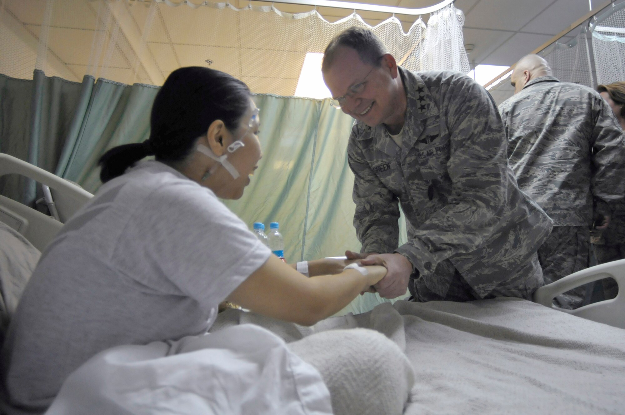 Air Force Surgeon General Lt. Gen. (Dr.) Charles B. Green visits Senior Airman Diane Bautista Feb. 13, 2011, during a visit to the Craig Joint Theater Hospital at Bagram Airfield, Afghanistan. Airman Bautista is a medic assigned to the 455th Expeditionary Medical Group. (U.S. Air Force photo/Tech. Sgt. Michael Voss) 