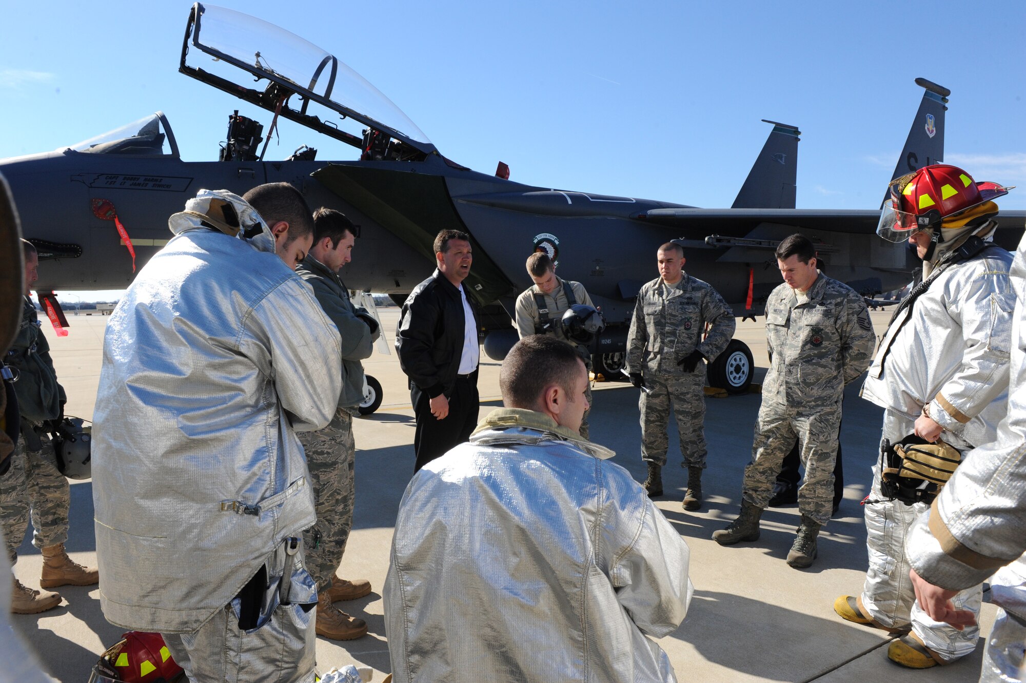 SEYMOUR JOHNSON AIR FORCE BASE, N.C. -- After completing aircraft egress training, the firefighters from the 4th Civil Engineer Squadron meet to debrief the scenario here, Feb. 15, 2011.  Firefighters practice responding to disabled aircraft with potential hazards and injured aircrew members to ensure they know how to safely respond to aircraft mishaps. (U.S. Air Force photo/Staff Sgt. Courtney Richardson) (RELEASED)