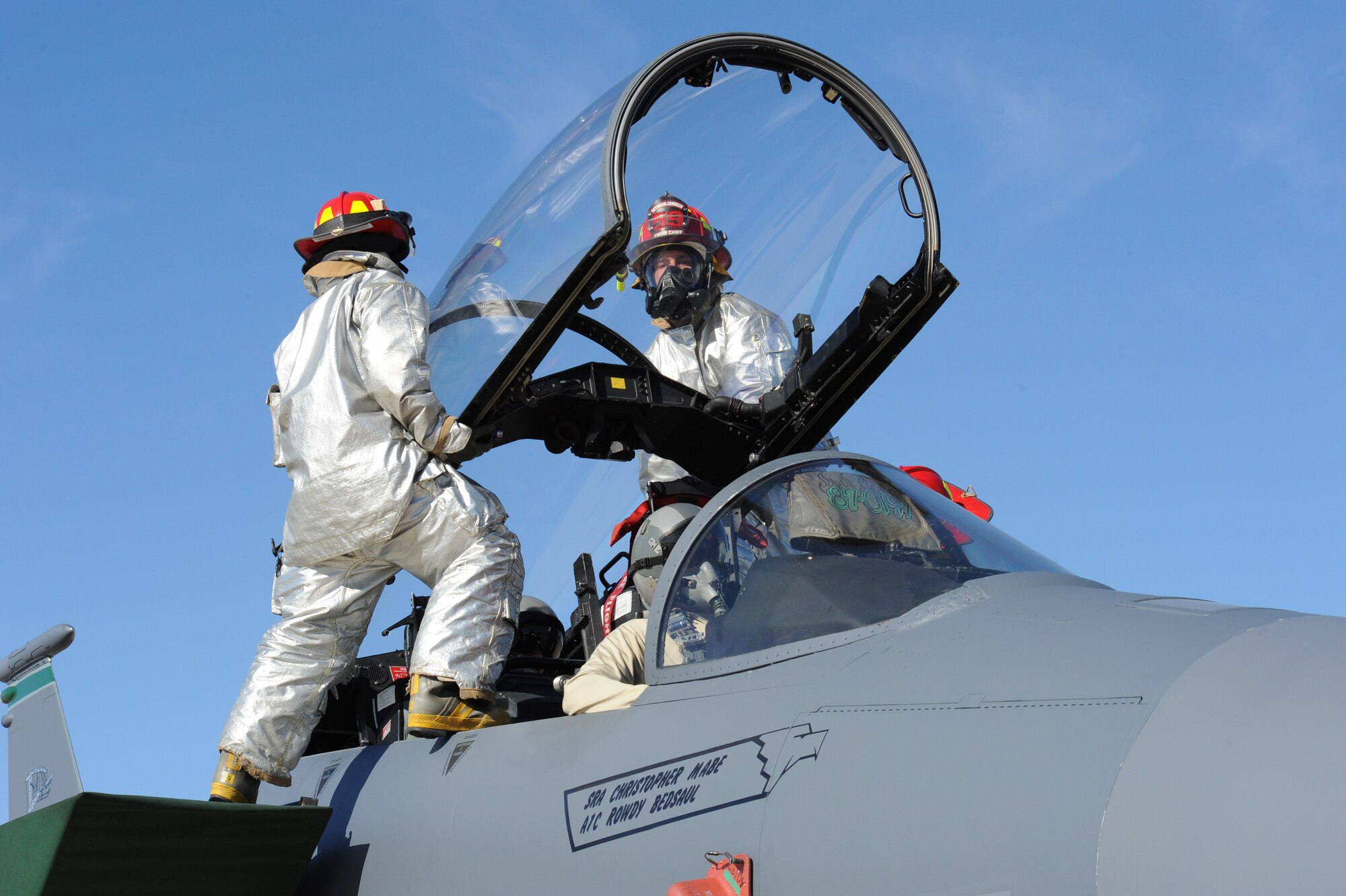 SEYMOUR JOHNSON AIR FORCE BASE, N.C. -- Firefighters from the 4th Civil Engineer Squadron lift the canopy to remove simulated incapacitated aircrew during egress training here, Feb. 15, 2011.  There are five ways to gain entry into the canopy: normal entry, sawing through canopy, jettison the canopy, lifting and manually pumping the canopy. (U.S. Air Force photo/Staff Sgt. Courtney Richardson) (RELEASED)