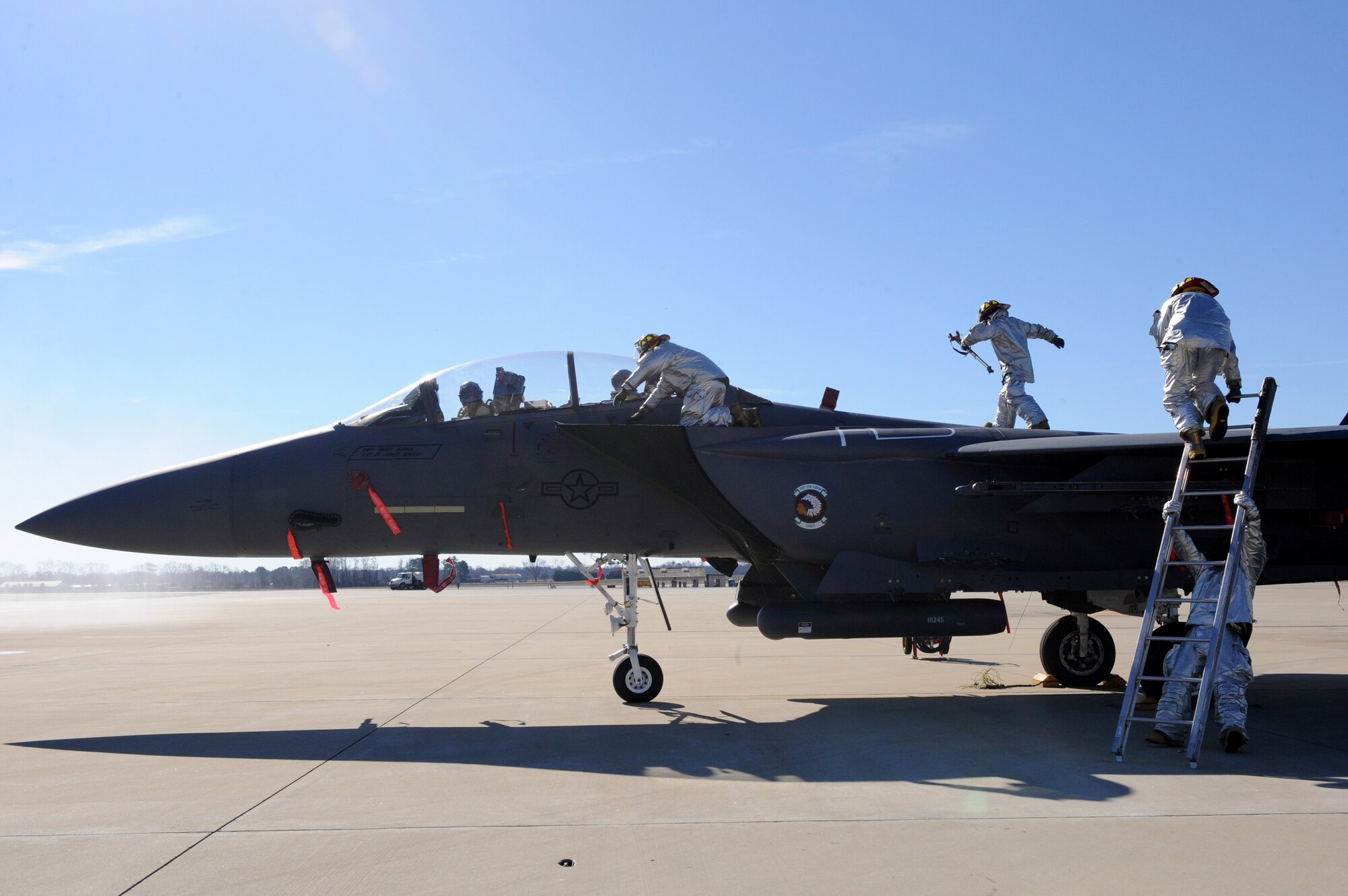 SEYMOUR JOHNSON AIR FORCE BASE, N.C. -- Firefighters from the 4th Civil Engineer Squadron prepares to remove unresponsive aircrew from an F-15E during egress training here, Feb. 15, 2011. From the moment the firefighters touch the F-15E Strike Eagle, they have 90 seconds to safely remove all aircrew members. (U.S. Air Force photo/Staff Sgt. Courtney Richardson)(RELEASED)