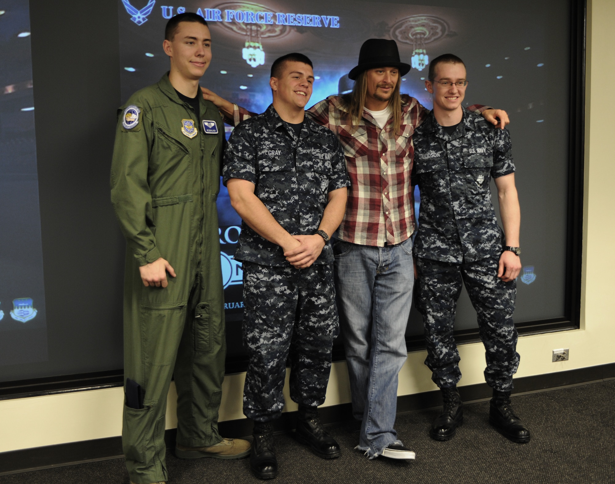 Two Joint Base Charleston Sailors, and Airman 1st Class Devon Lynch, 17th Airlift Wing, pose for a photo with Kid Rock when he visited the 315th Airlift Wing Feb. 16, 2011. ((US Air Force photo/Tech Sgt DeNoris Mickle)