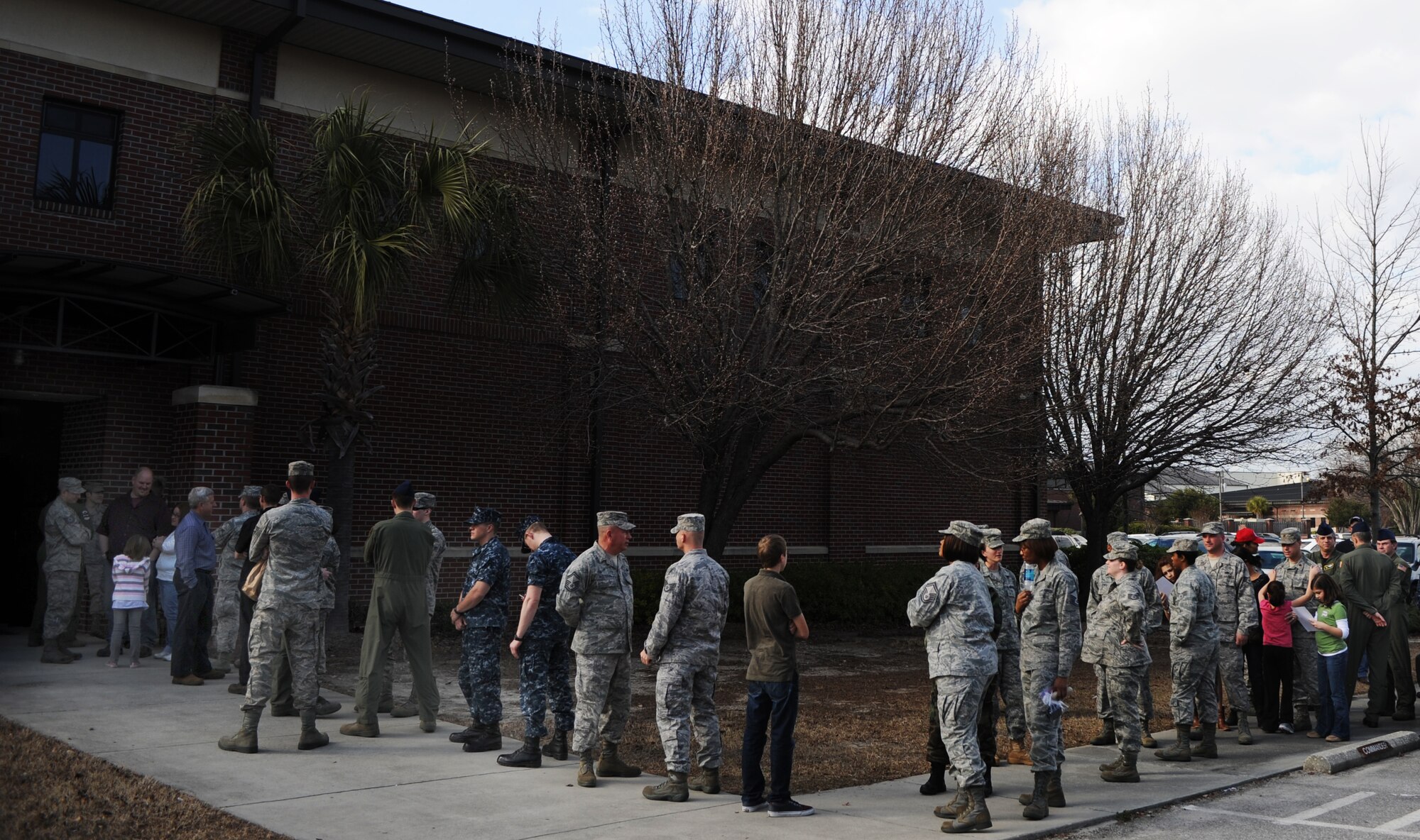 Joint Base Charleston service members, civilian employees and family members form a line to meet Kid Rock when he visited the 315th Airlift Wing Feb. 16, 2011. ((US Air Force photo/Tech Sgt DeNoris Mickle)